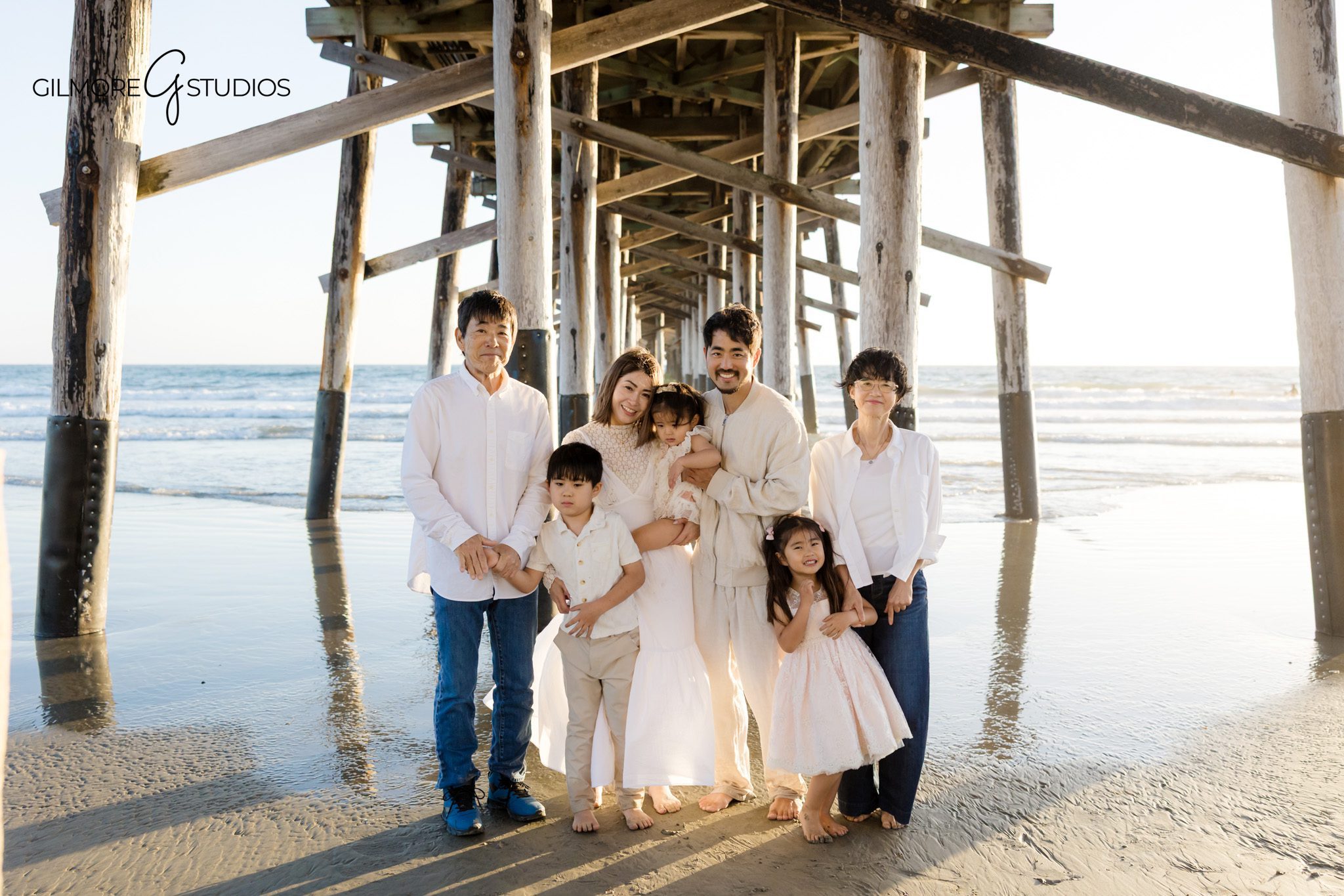 Multi generational family beach session Newport Beach
Family standing together at Newport Beach pier sand