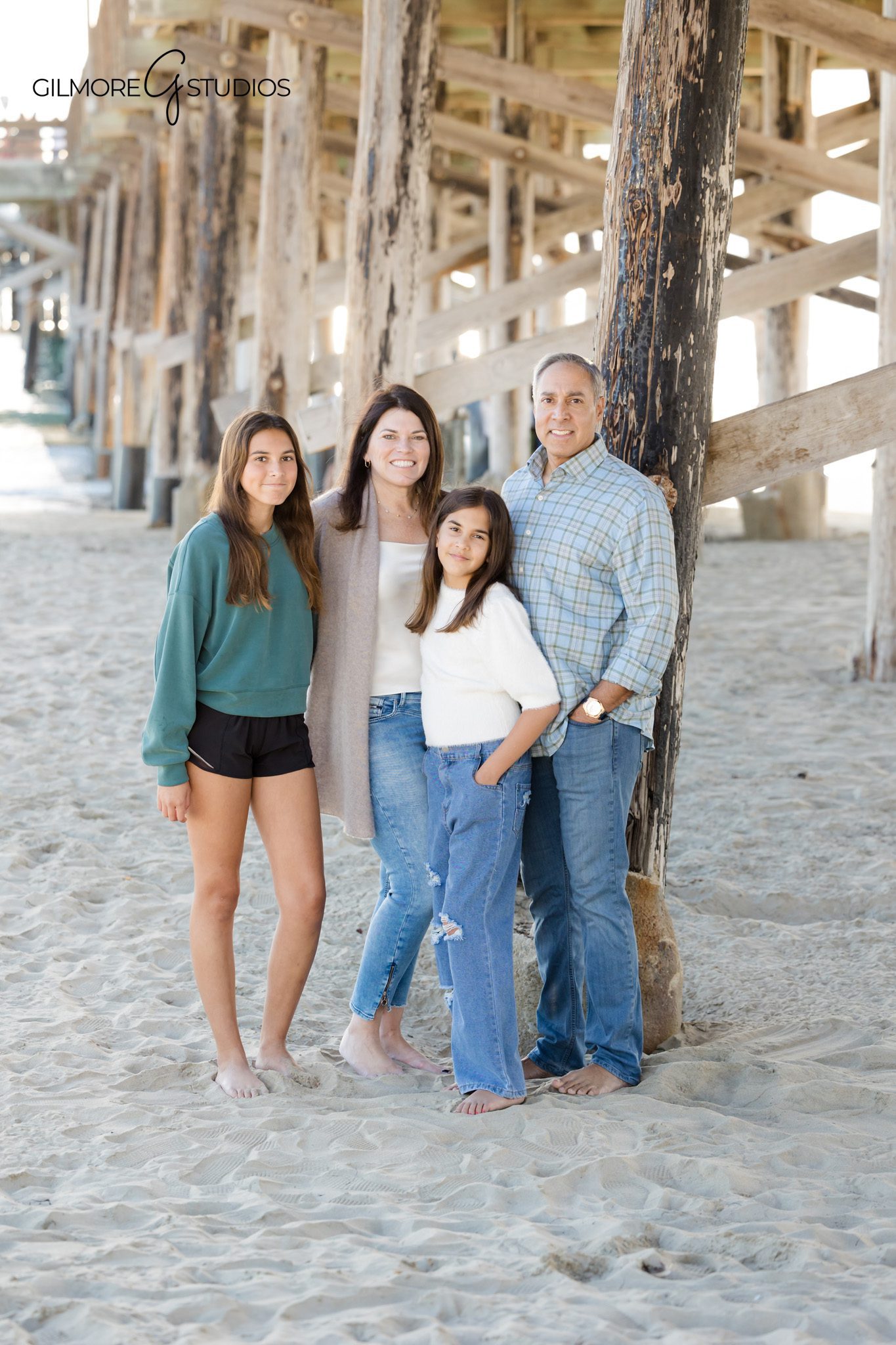 family photography Newport Beach under pier with soft natural lighting
Newport Pier family photographer candid beach session with children