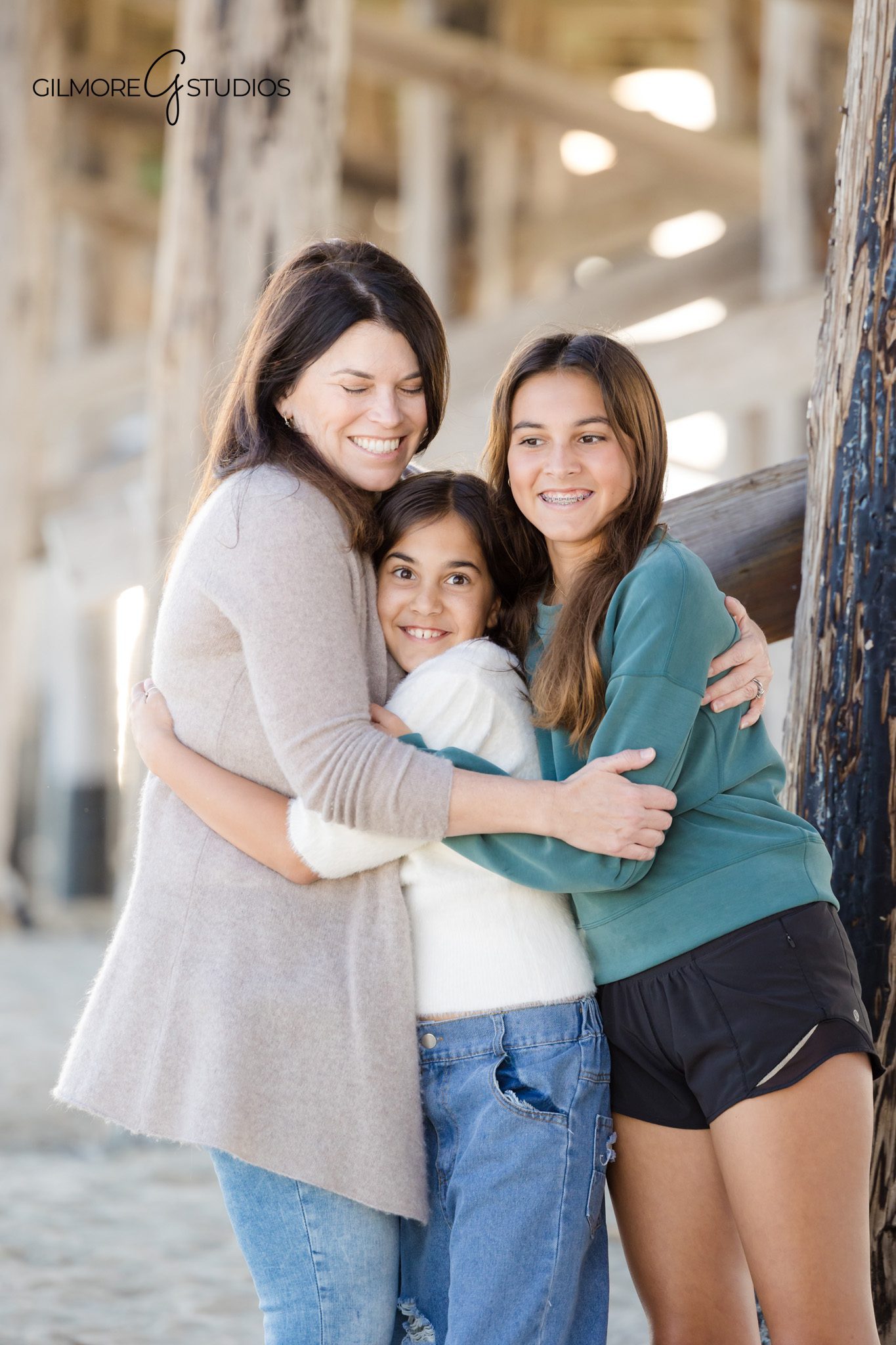 beach family portraits Newport Beach California under wooden pier
Orange County family photography session Newport Pier coastal scene