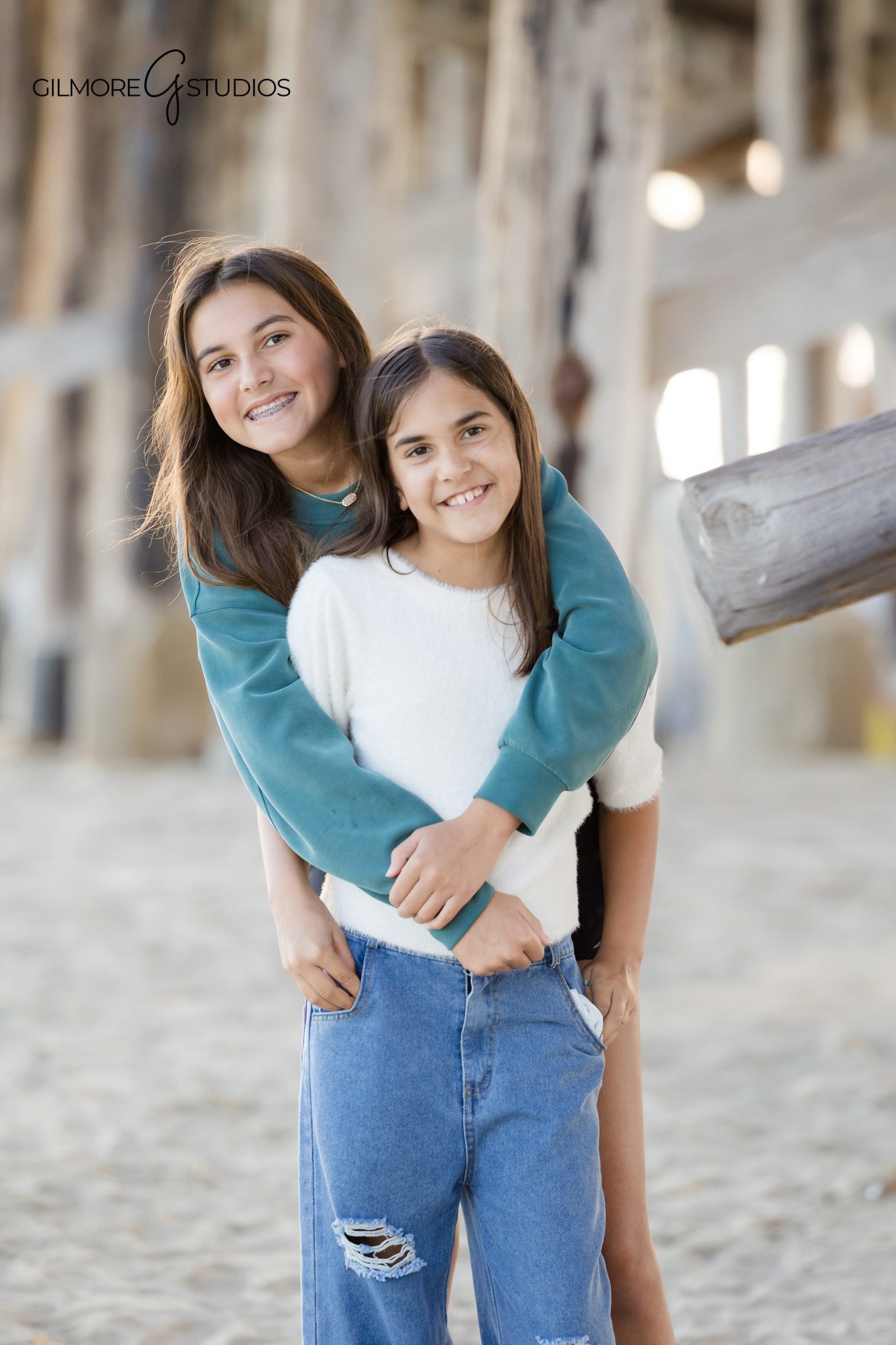 coastal family photography Newport Beach pier structure background
beach photography session Newport Pier family natural posing