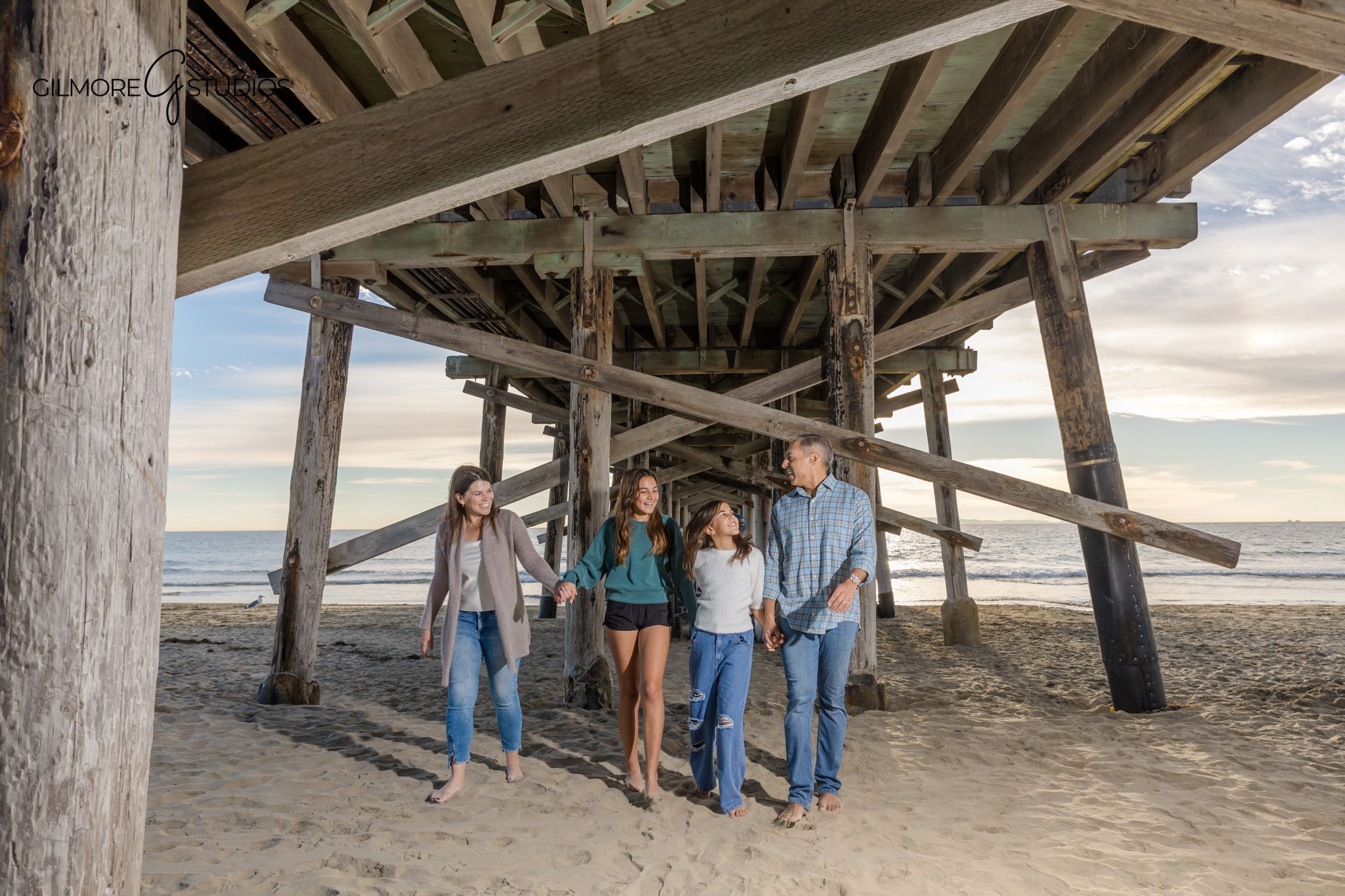 Newport Beach family photographer capturing seated beach portraits
family photography Newport Pier sitting poses natural beach session