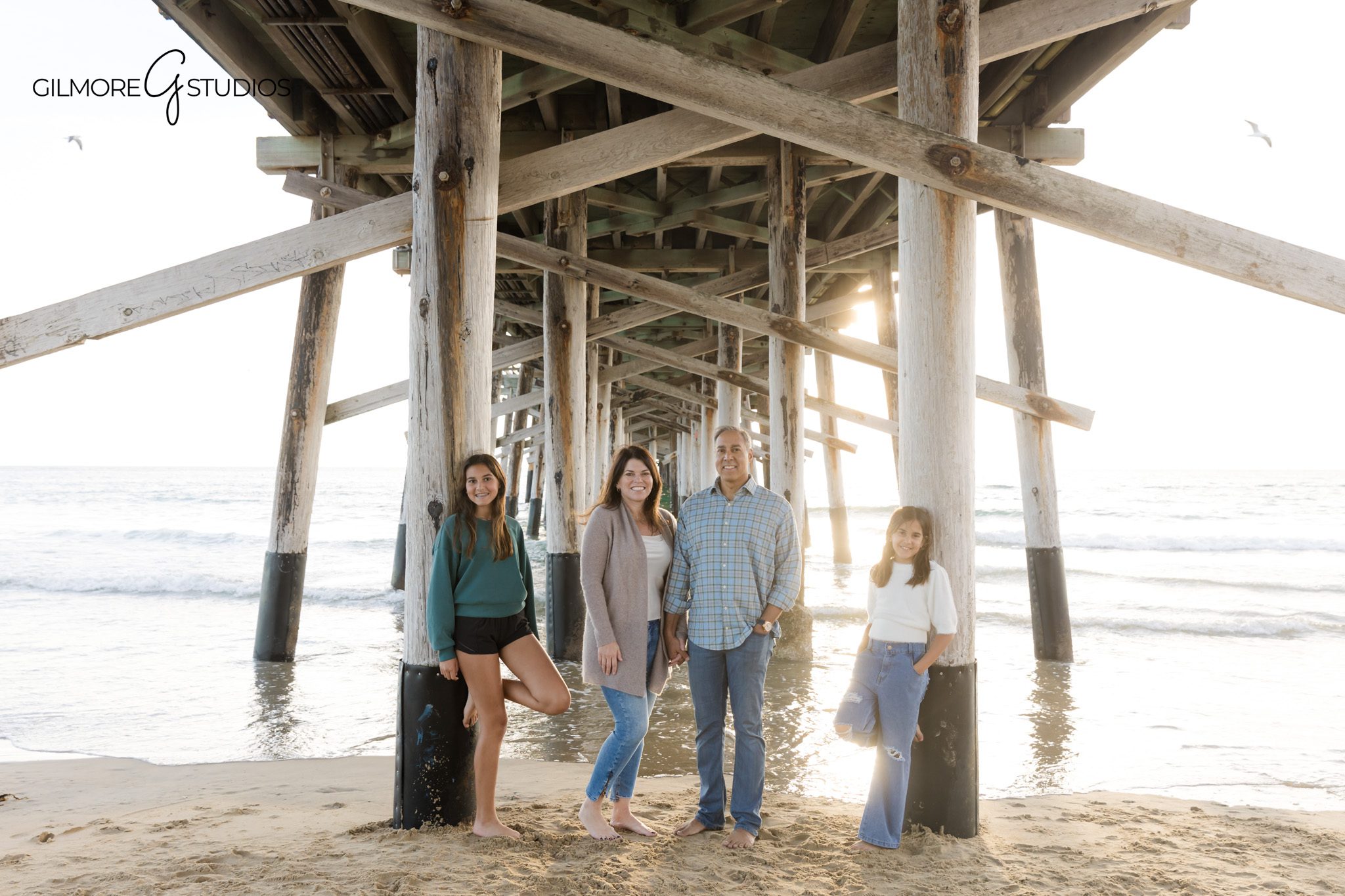 candid family portraits Newport Pier California beach setting
beach family photography Newport Beach relaxed movement photos
