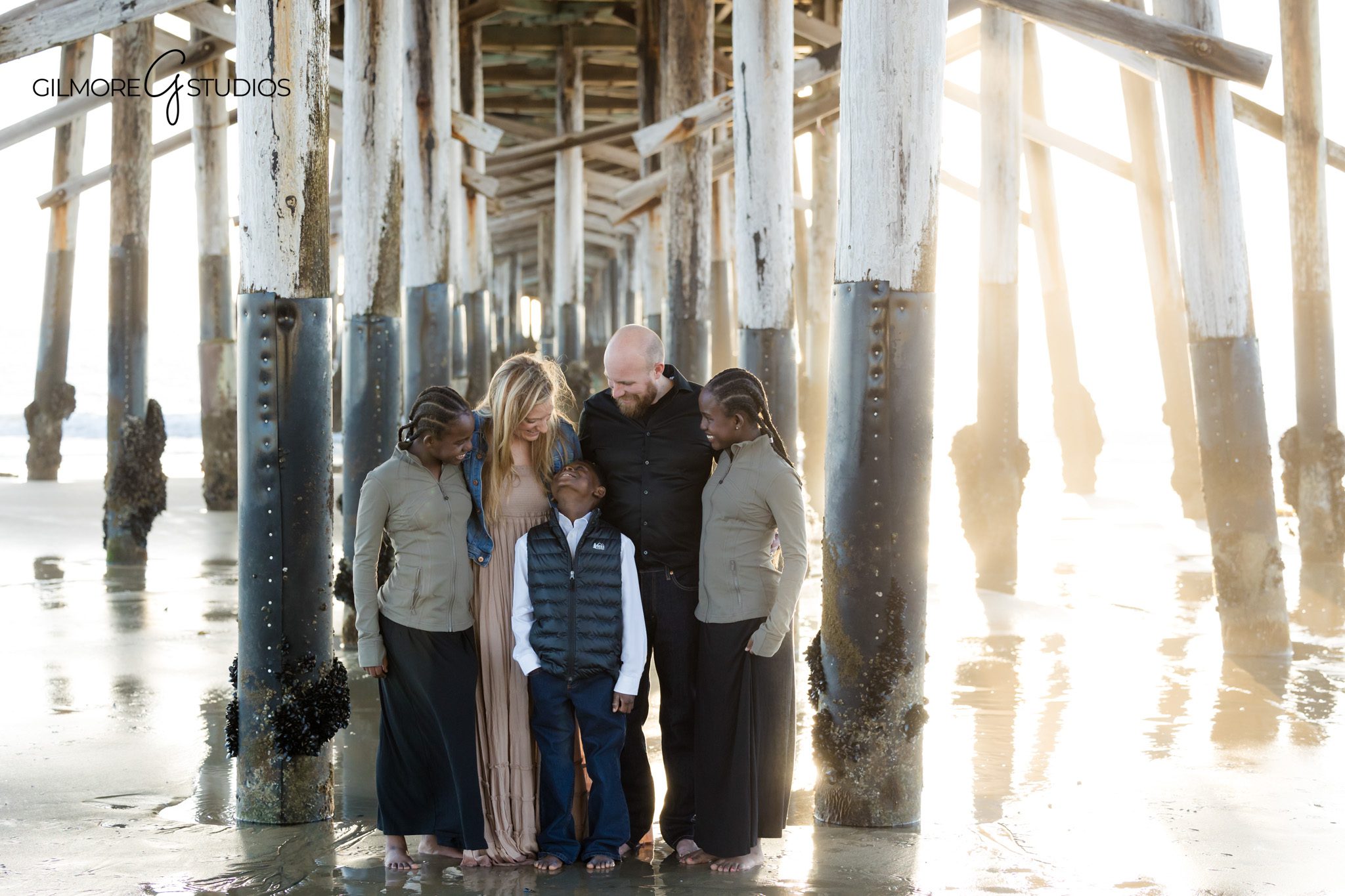 Newport Beach family photographer capturing kids hugging candid moment
Newport Pier family photography sibling connection beach portrait