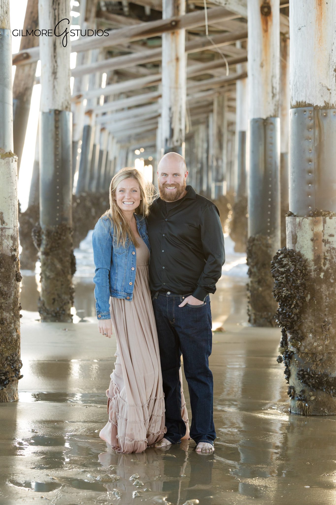 Newport Beach family photographer capturing full family under pier symmetry
Newport Pier family photography symmetrical composition beach portrait