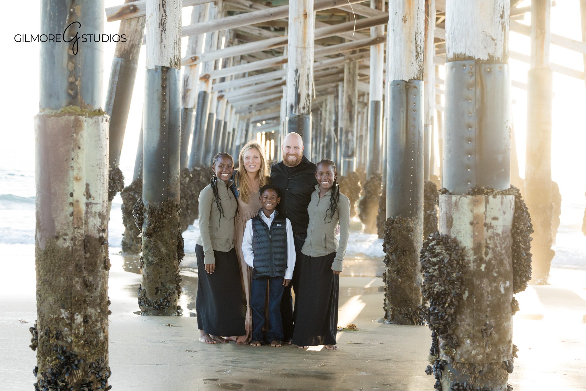family photography Newport Beach CA under pier golden light portrait
beach family portrait Newport Pier California natural light session