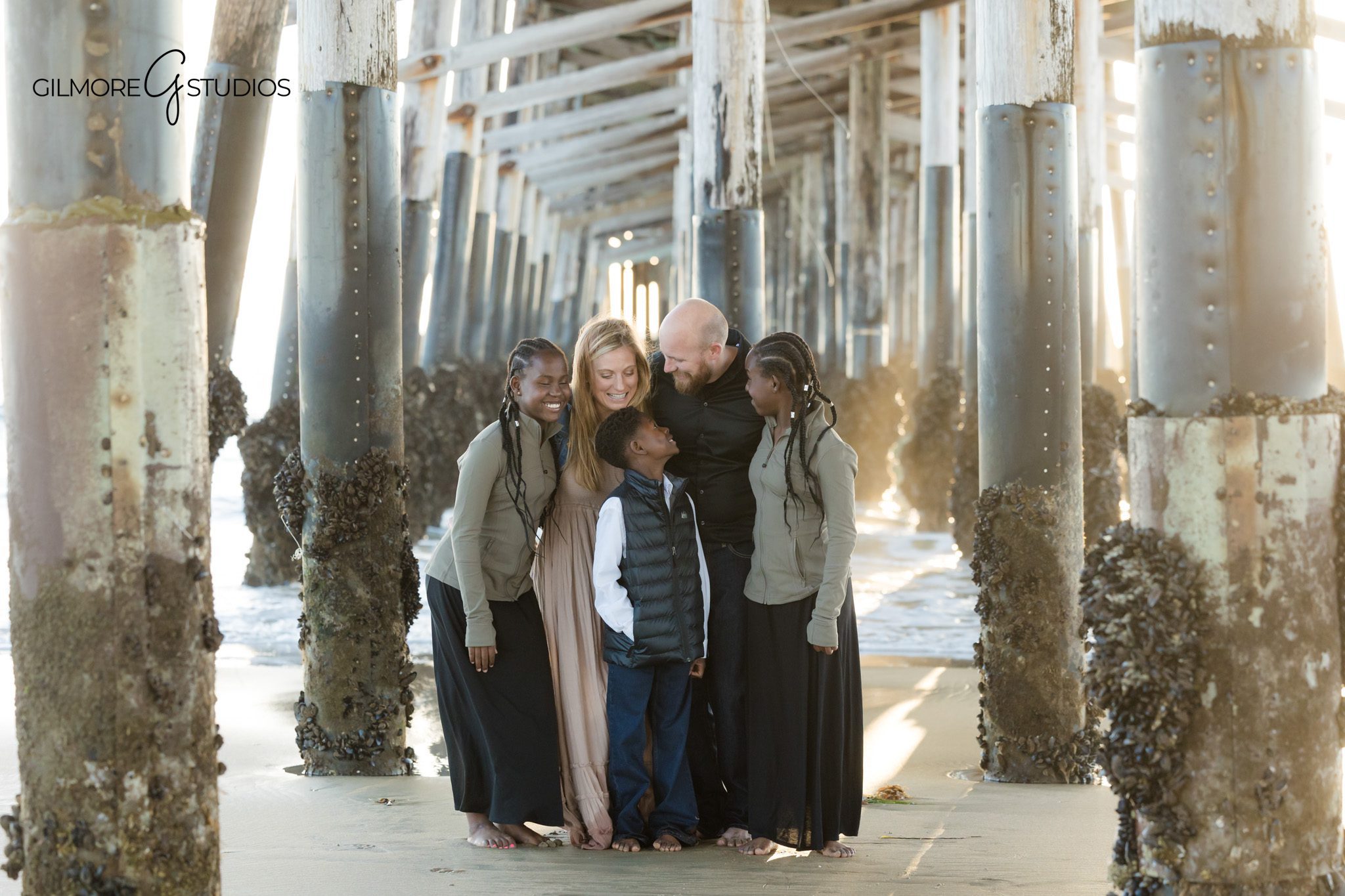 Newport Beach family photographer capturing family walking holding hands
Newport Pier family photography connection walking beach session
