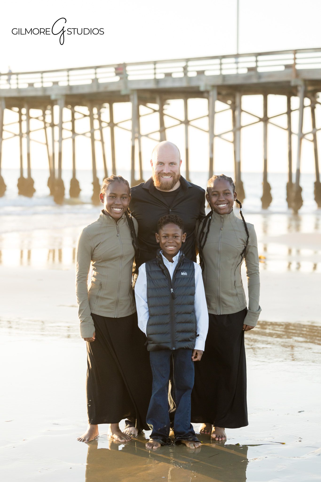 Newport Beach family photographer capturing relaxed standing family portrait
Newport Pier family photography natural posing beach family session