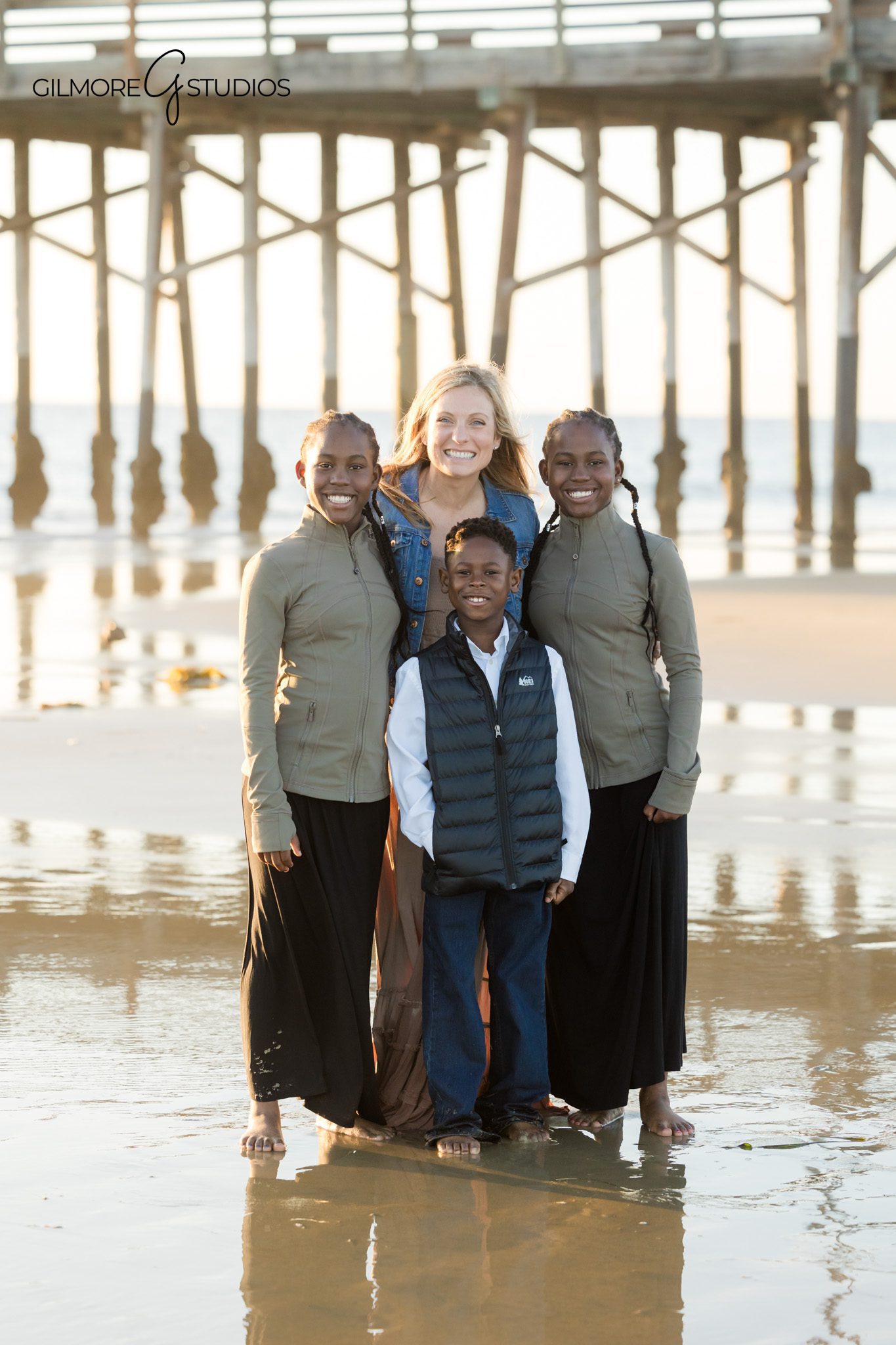 beach family photos Newport Beach casual standing portrait
coastal family photography Newport Pier relaxed group pose