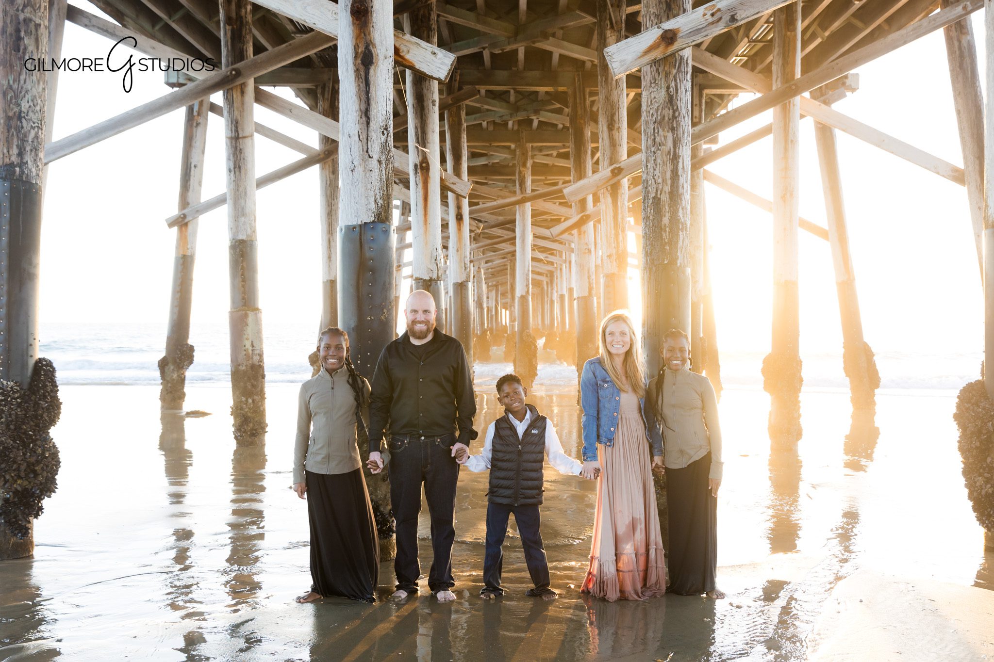 Newport Beach family photographer capturing golden glow beach portrait
Newport Pier family photography warm light ocean reflection portrait