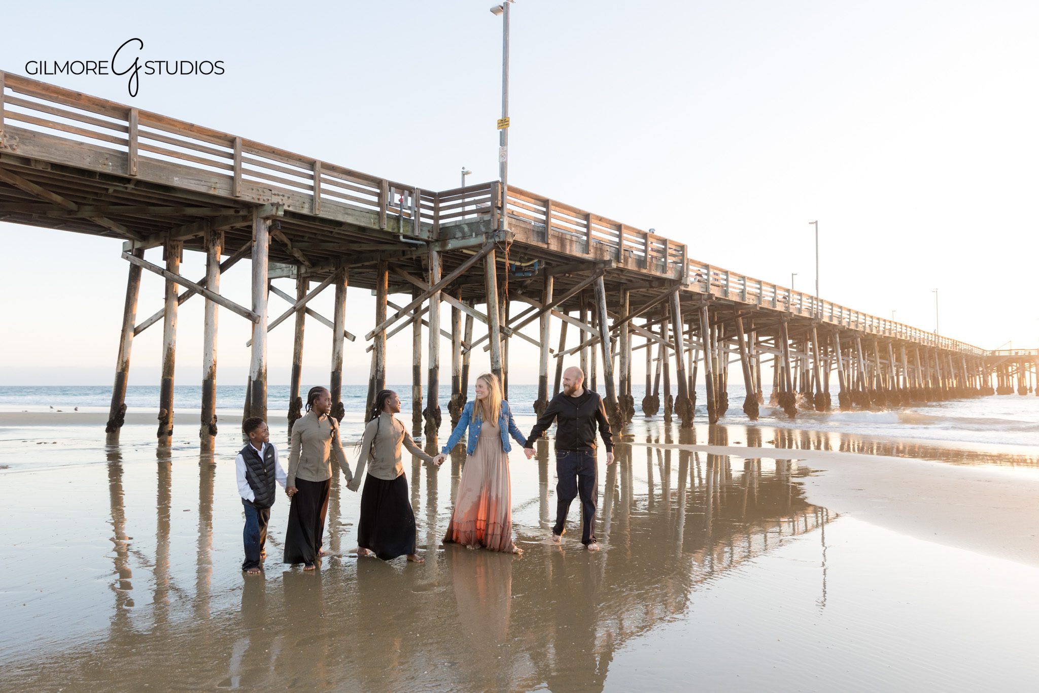 Newport Beach family photographer capturing family walking on beach
Newport Pier family photography walking together candid beach session