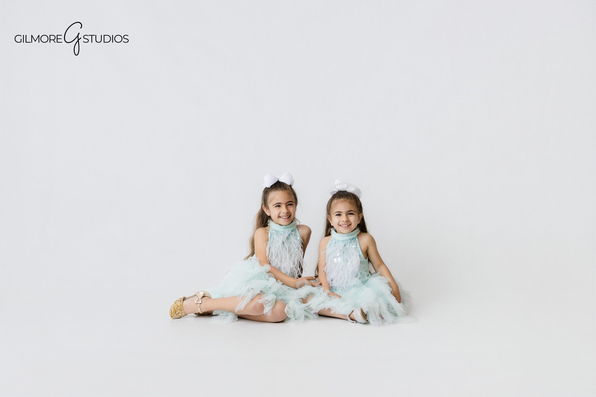 Gilbert AZ birthday photographer capturing sisters in matching mermaid dresses, pastel aqua birthday portrait session