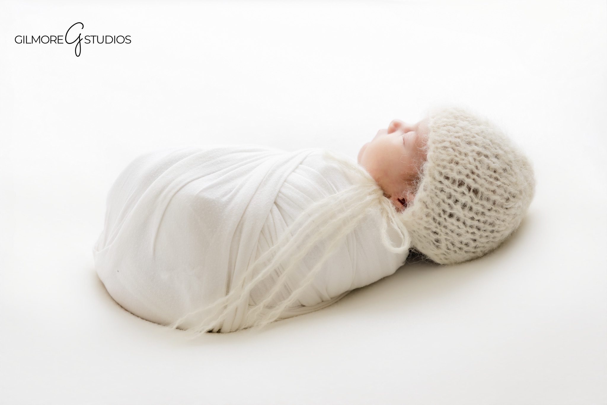 Newborn studio session Gilbert Arizona with floral newborn headband and timeless baby photography