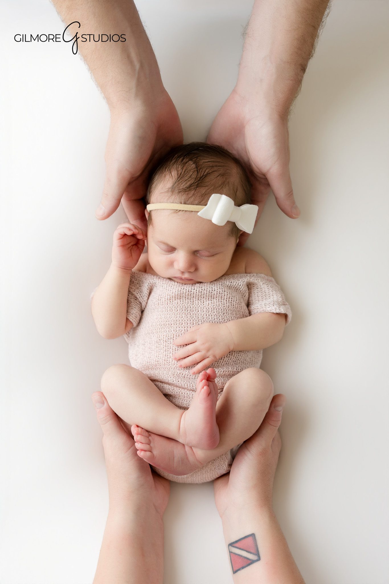 Newborn studio photographer Gilbert AZ portrait of baby girl posed in rustic basket with soft neutral styling