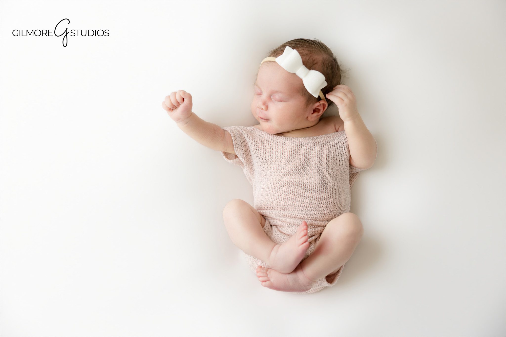 Gilbert Arizona newborn photography of baby girl sleeping in wooden basket with blush pink wrap
