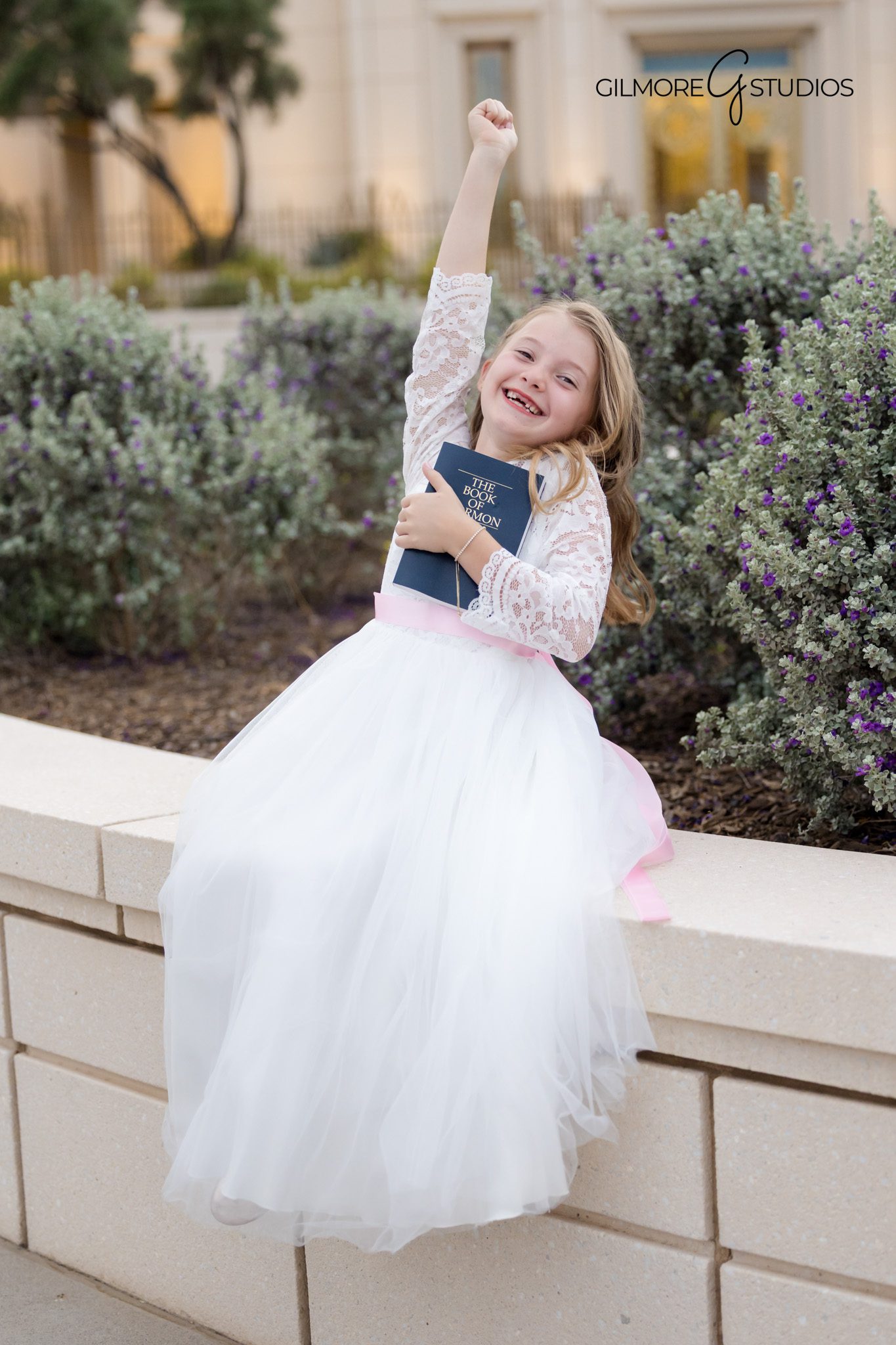 Young girl baptism portrait holding scriptures at Gilbert Arizona Temple
Gilbert Arizona LDS baptism photography with white baptism dress and temple background