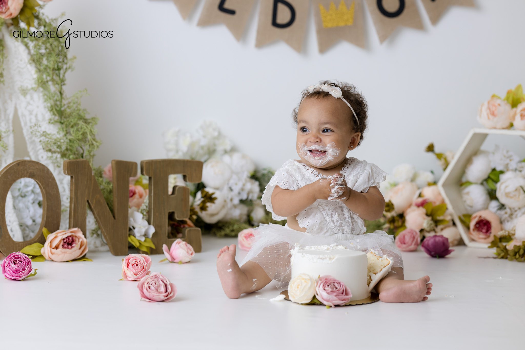 Gilbert cake smash photographer capturing one year old milestone portraits with flowers