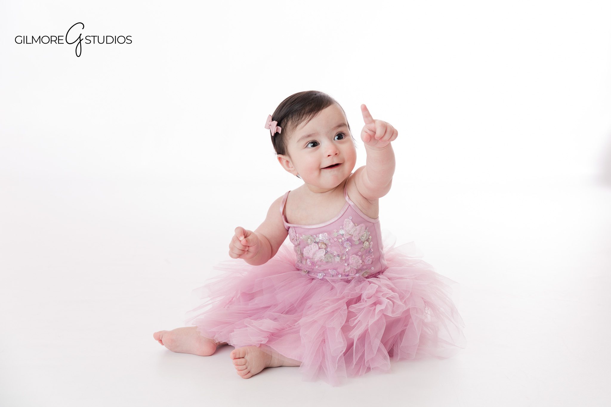 Spring baby milestone session in Newport Beach with baby sitting up in studio
Newport Beach baby milestone photographer capturing a sitting-up baby portrait