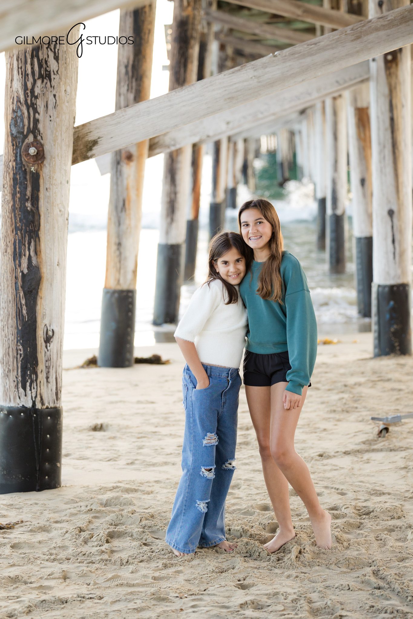 Family photos at Newport Pier with soft sunset sky and ocean backdrop
November beach family session at Newport Pier in Newport Beach California
