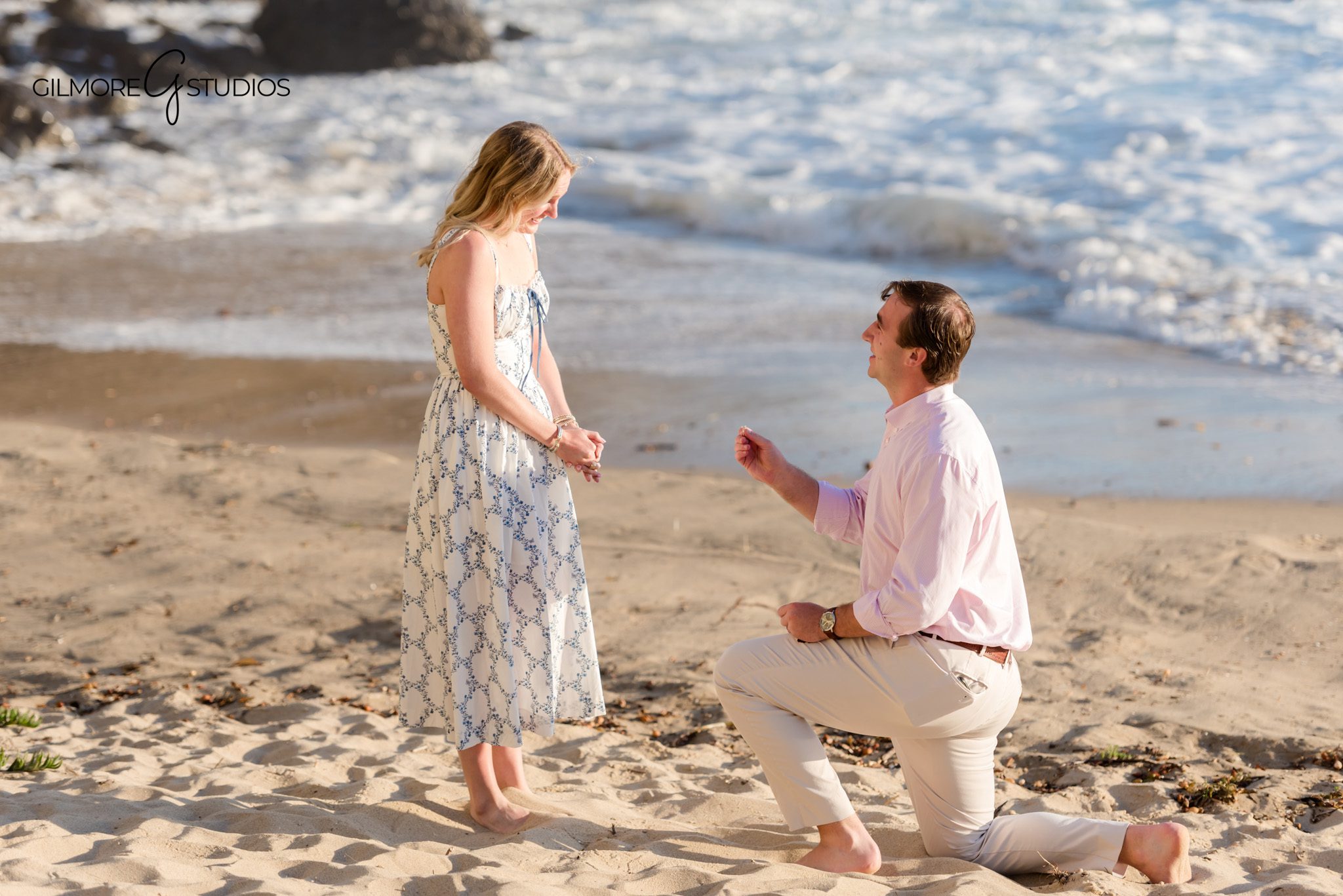 Groom proposing on the sand at Emerald Bay in Southern California
Newly engaged couple standing near the water at Emerald Bay