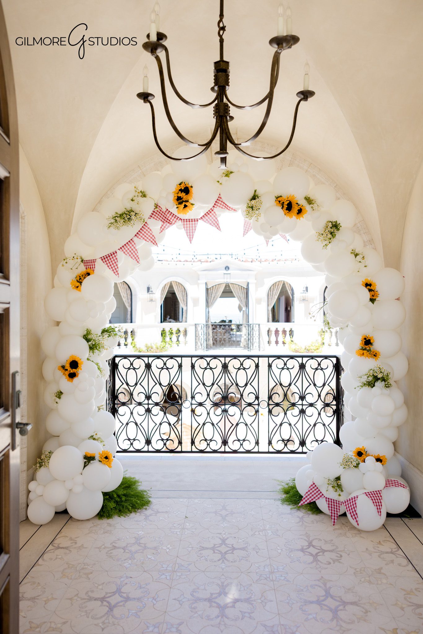 Orange County baby shower photographer capturing a private estate celebration
Baby shower detail photo with sunflowers, gingham accents, and custom signage