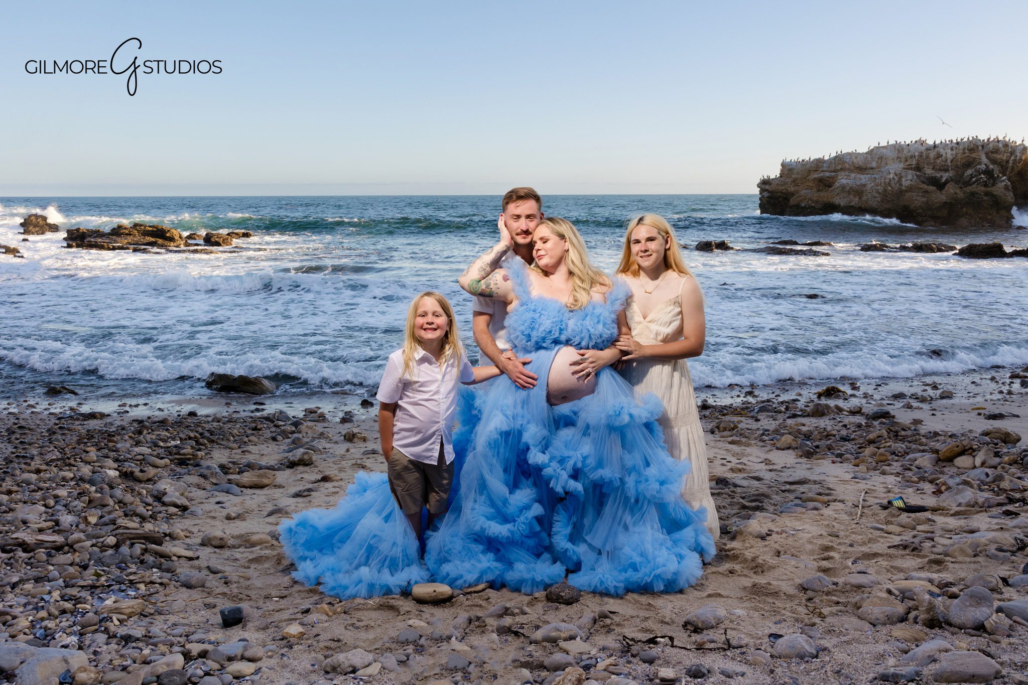 Parents-to-be holding hands during a Corona del Mar maternity photo session
Newport Beach maternity photography with a flowy dress and coastal cliffs