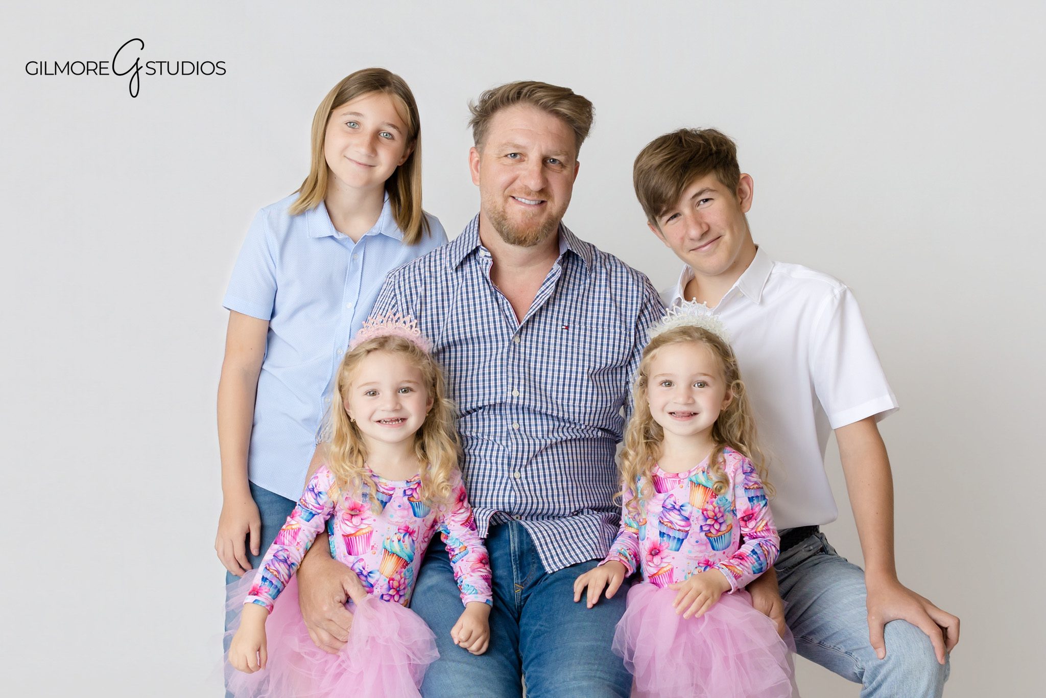 Twin sisters laughing together during Newport Beach birthday portraits
Unicorn cake smash photos with twin girls and soft pastel colors