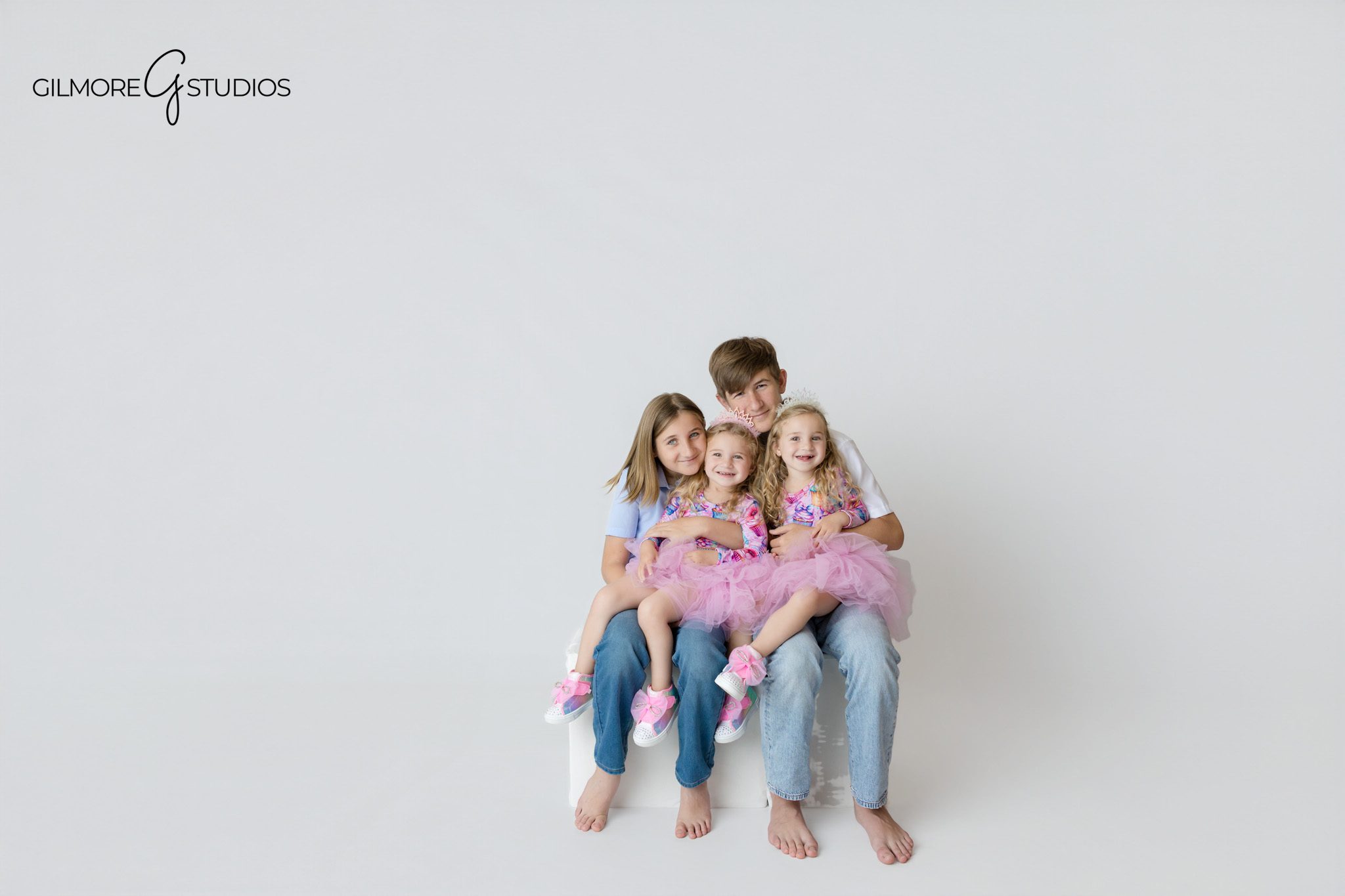 Twin sisters wearing matching pastel outfits for birthday photos
Unicorn birthday portraits with twin girls and two decorated cakes