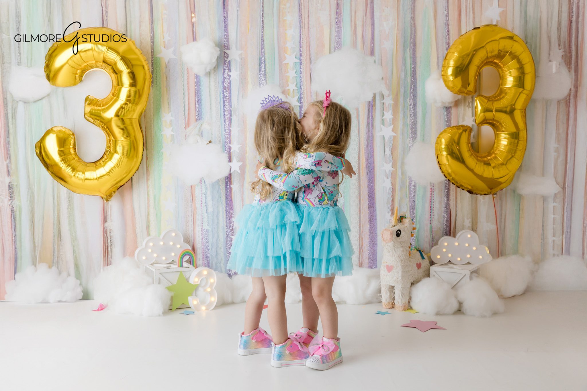 Unicorn birthday setup with twin girls, cakes, balloons, and streamers
Orange County birthday photographer capturing a twin cake smash session