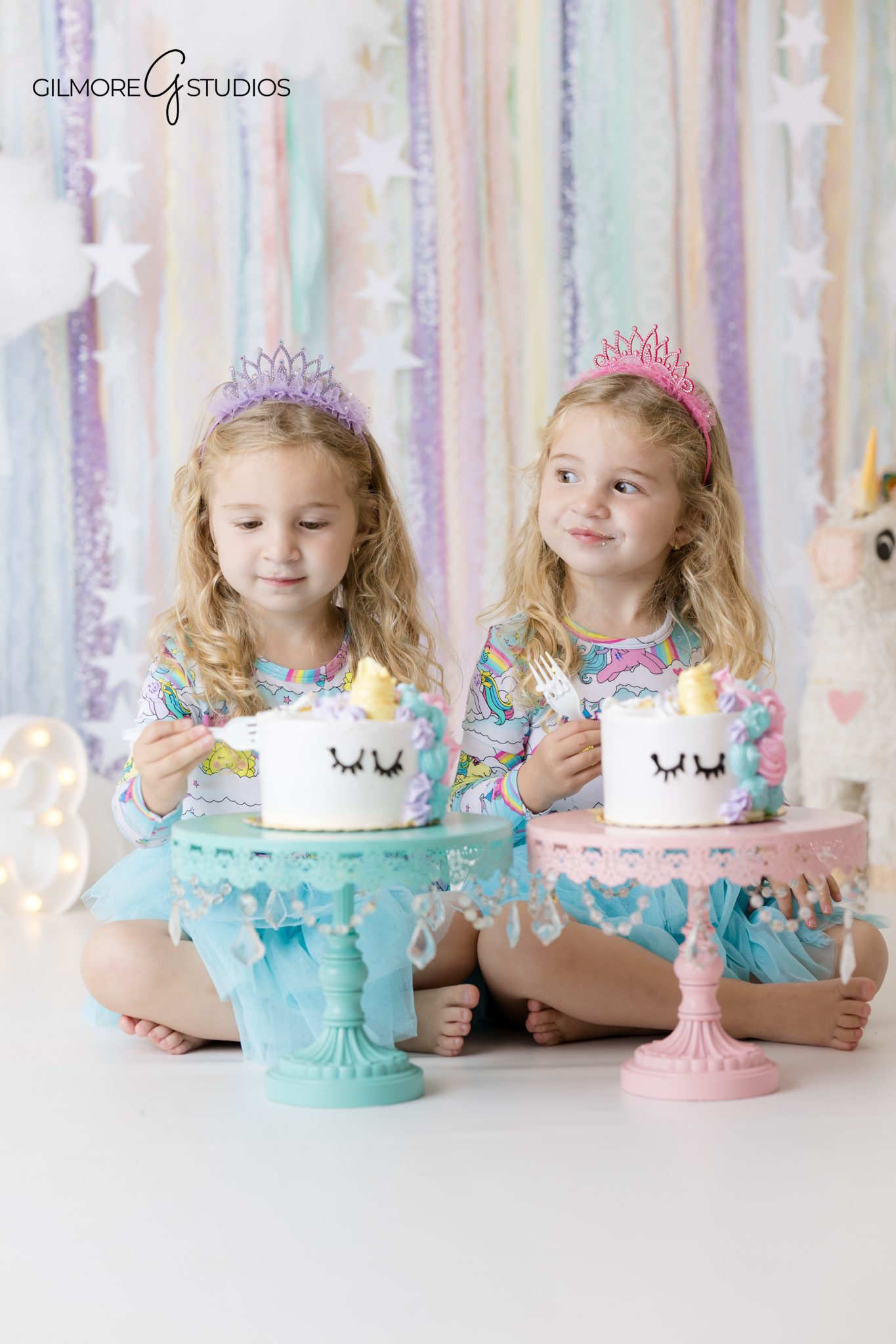 Twin cake smash session with two unicorn cakes and pastel backdrop
Newport Beach children photographer capturing twin birthday portraits