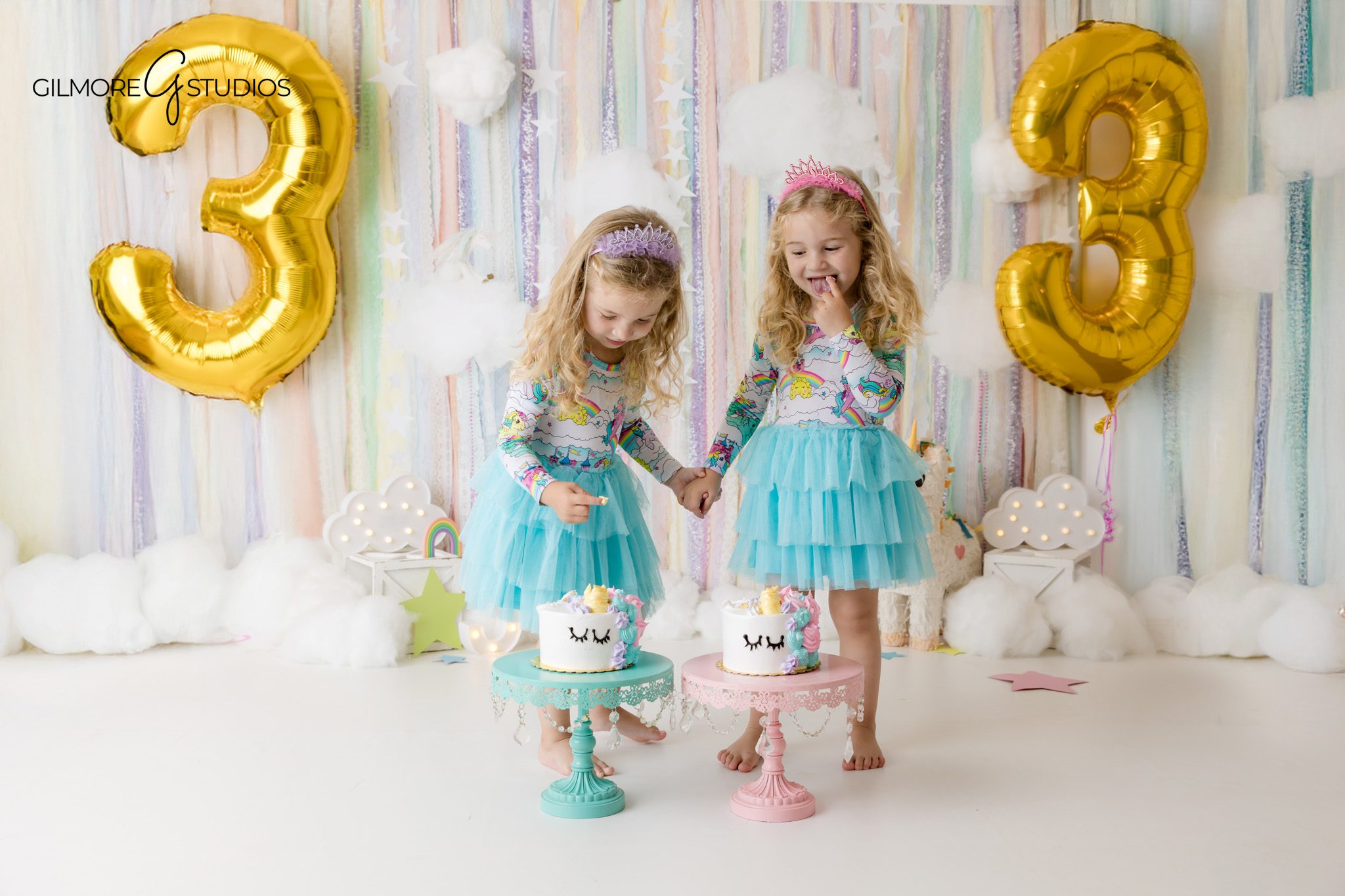 Twin sisters celebrating their birthday with a pastel unicorn setup
Newport Beach birthday portraits for twin girls with unicorn cakes