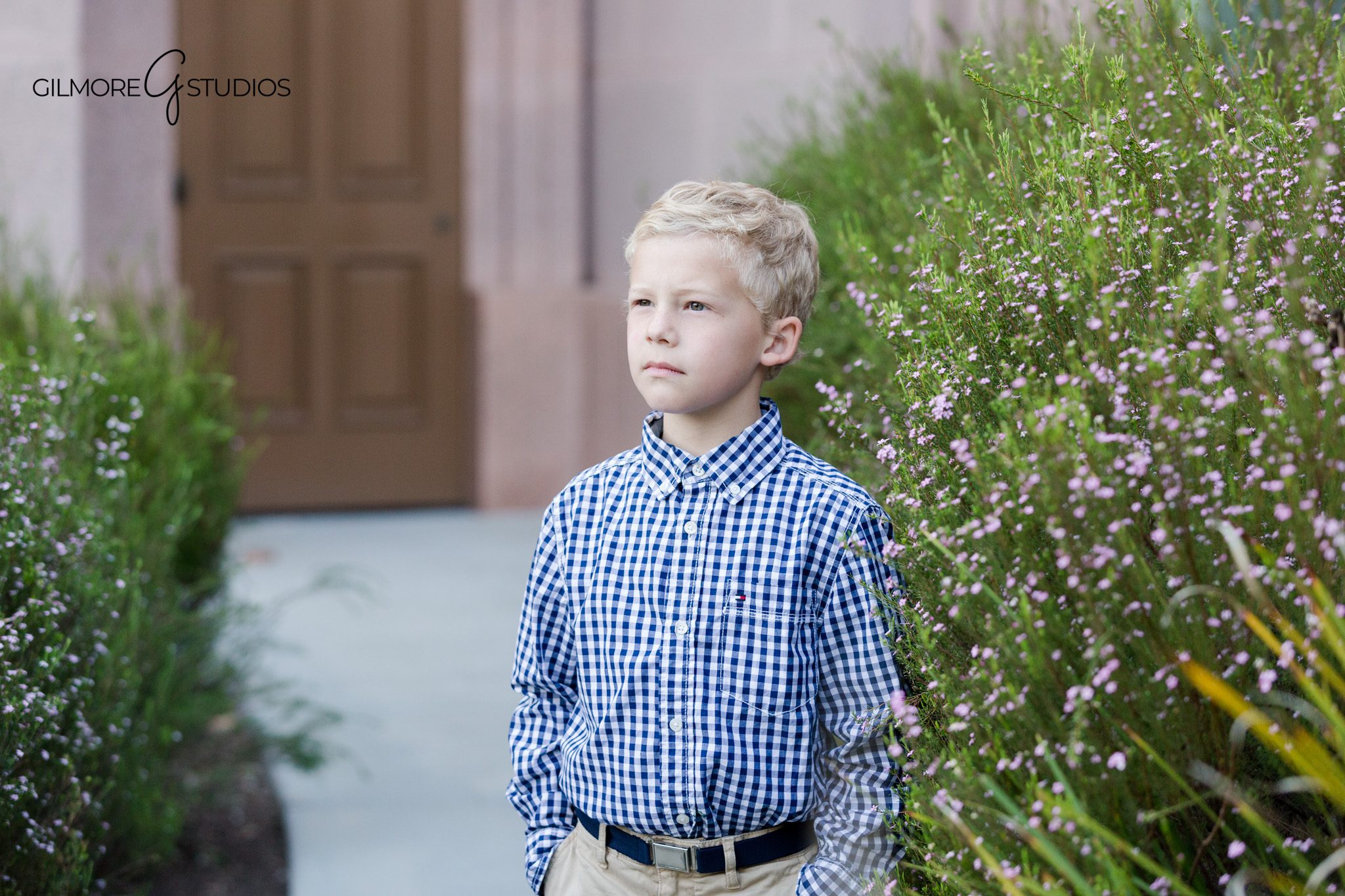 Boy standing on sidewalk during temple baptism session
Newport Beach baptism portrait with soft garden background