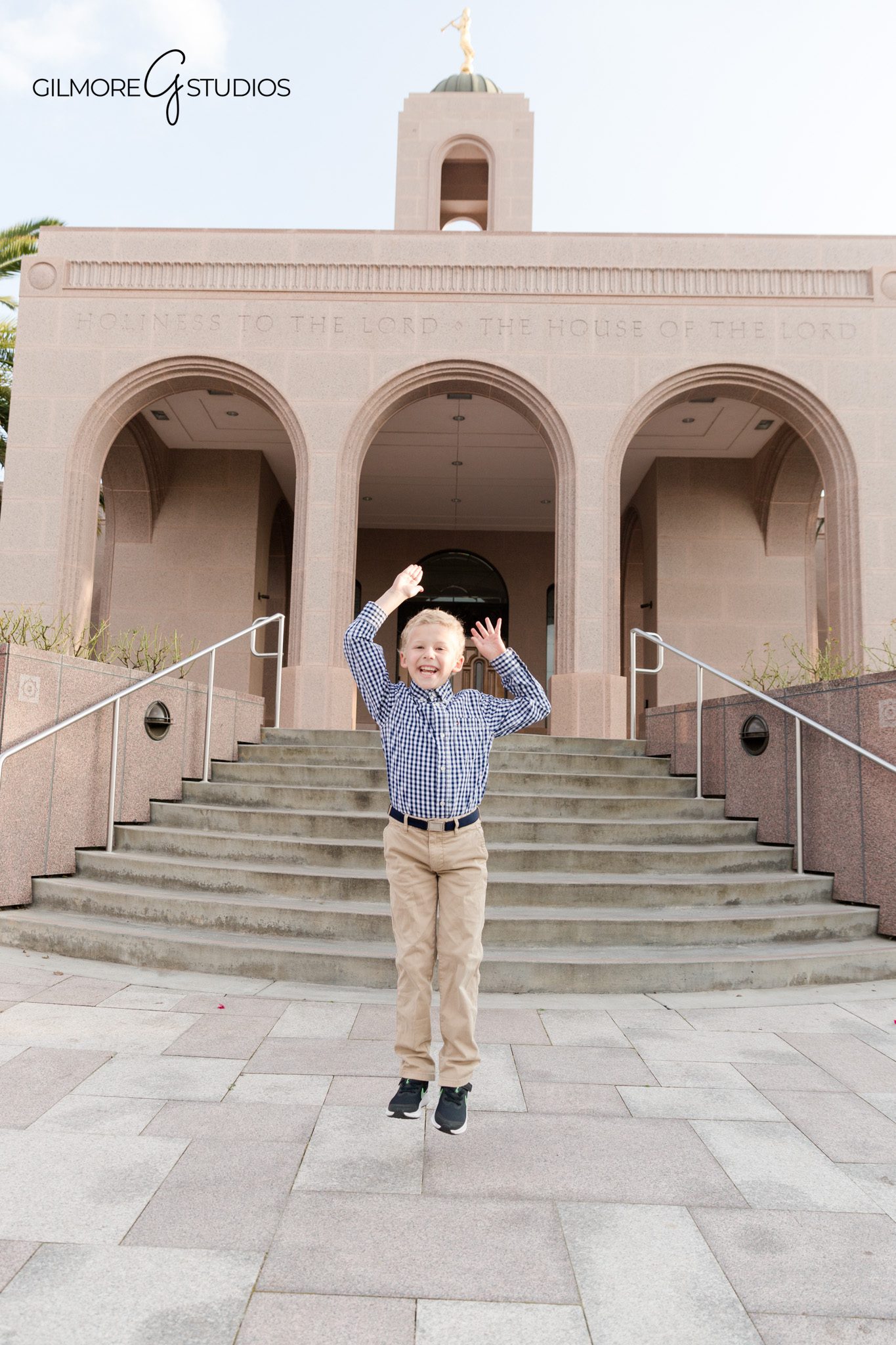 Child reading scriptures near Newport Beach Temple gardens
Boy sitting by flowers during Newport Beach LDS baptism photos