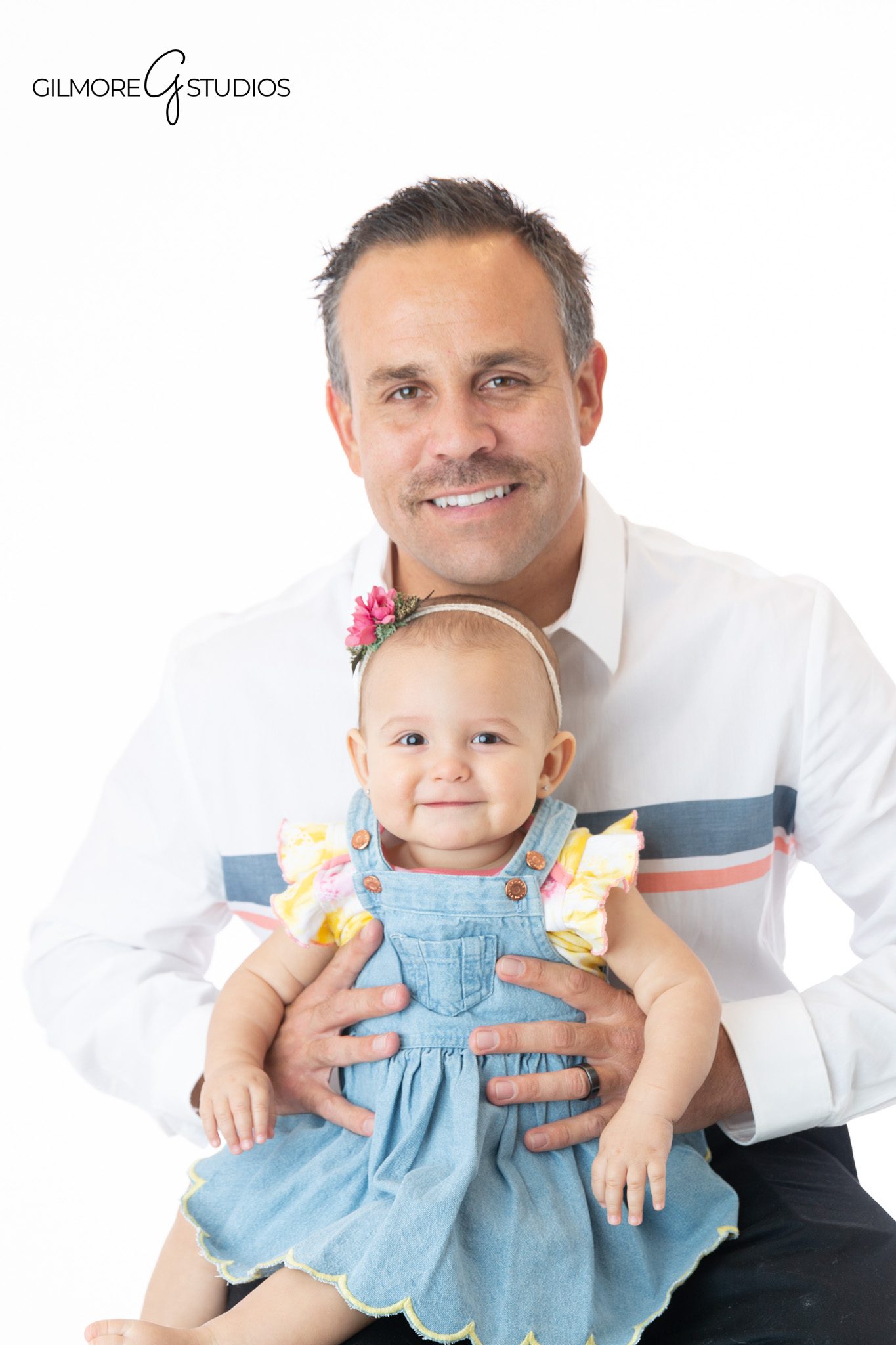 Family of three portrait with baby sitting up in front
Family of four portrait with sitting up baby and older sibling