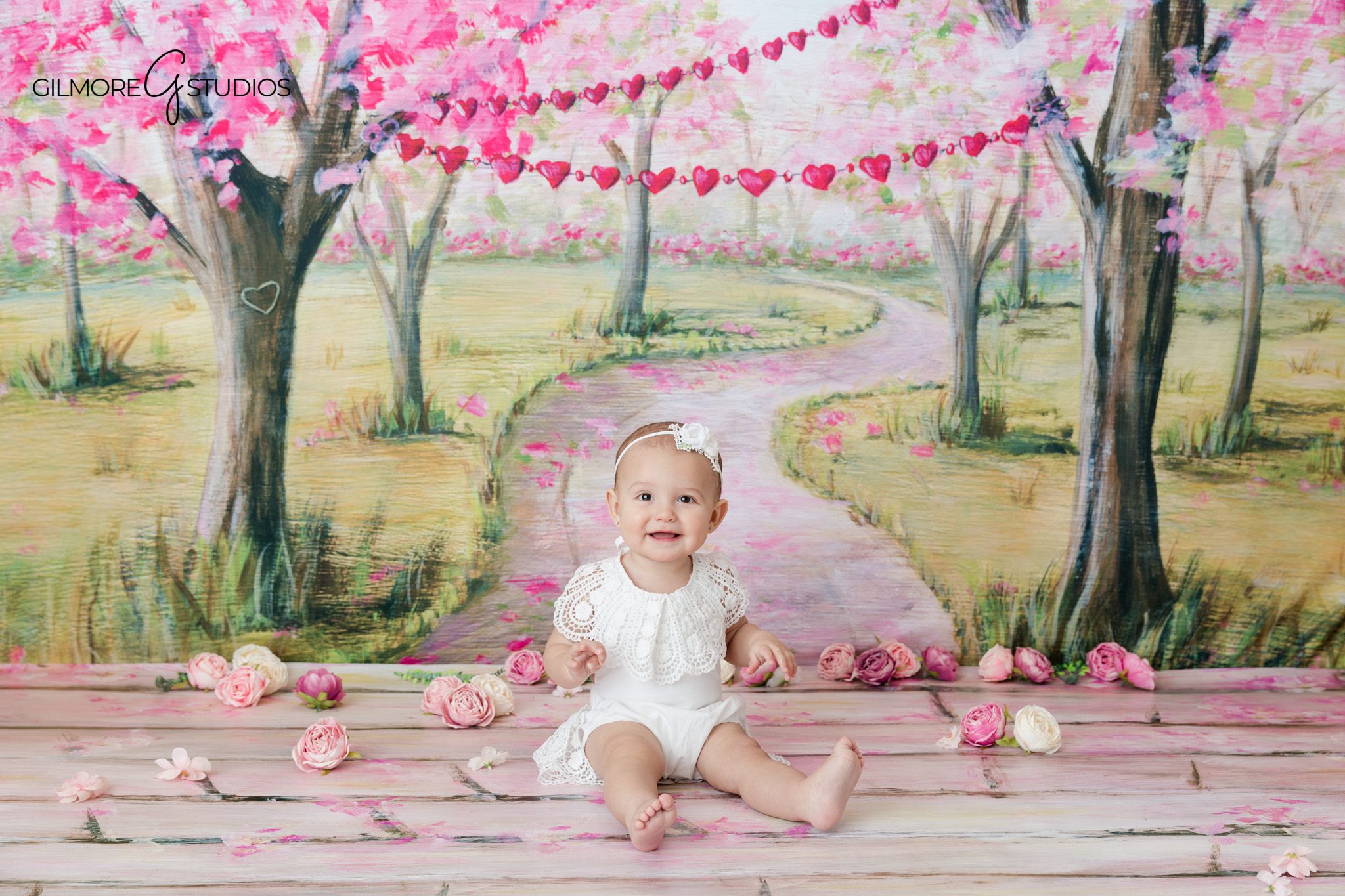 Family portraits with baby before solo sitting up milestone photos
Baby sitting independently with parents smiling nearby during family session