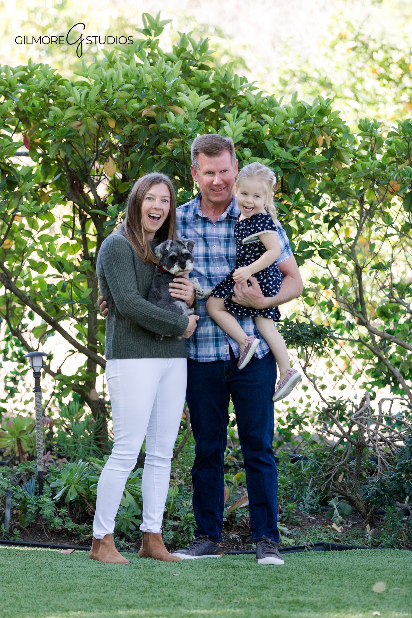 Backyard family session with dog included in the portraits
Lifestyle family photography in a backyard with natural light