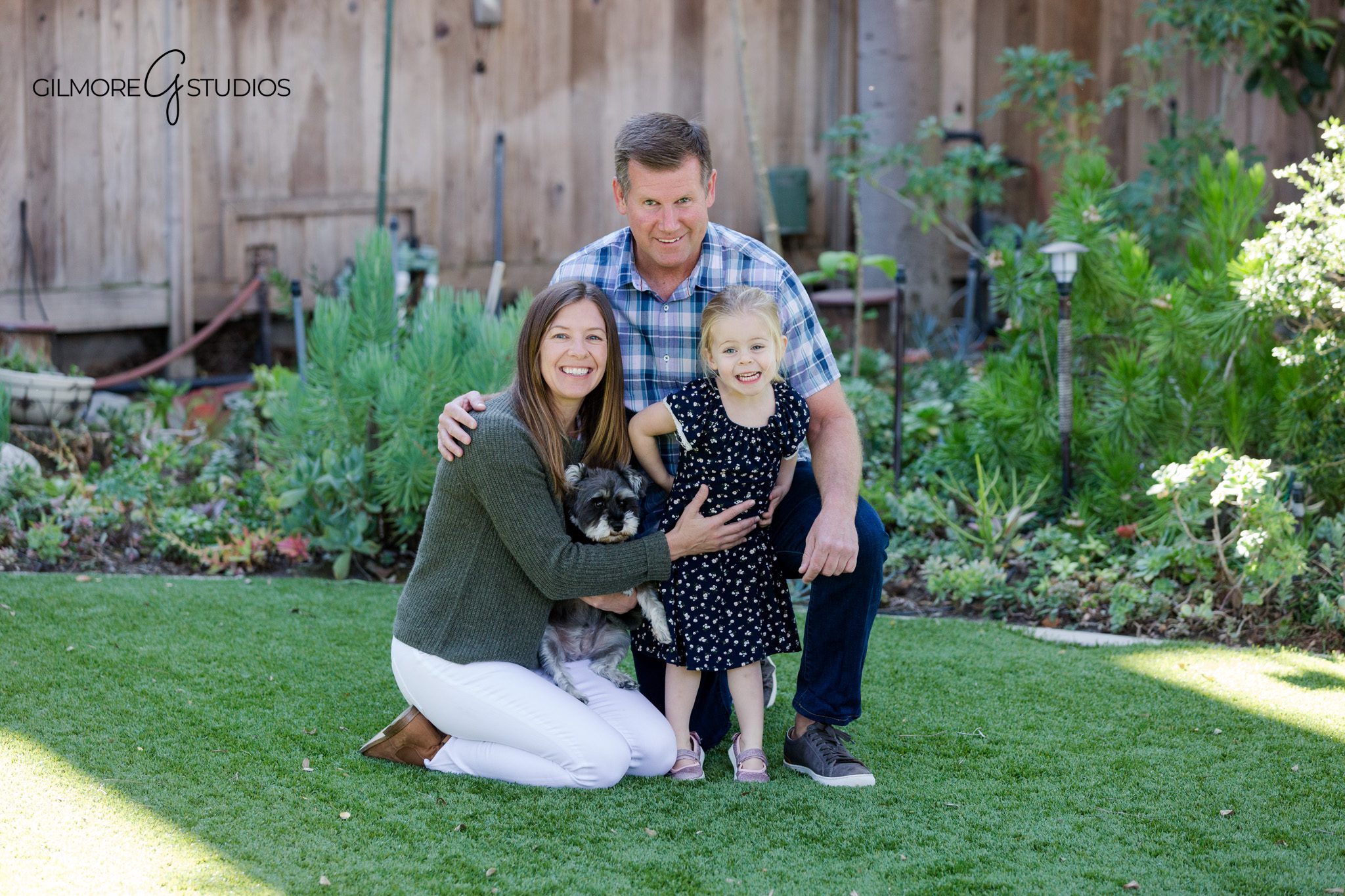 Child running across the lawn during backyard family photos
Backyard garden photos with family sitting together on outdoor steps