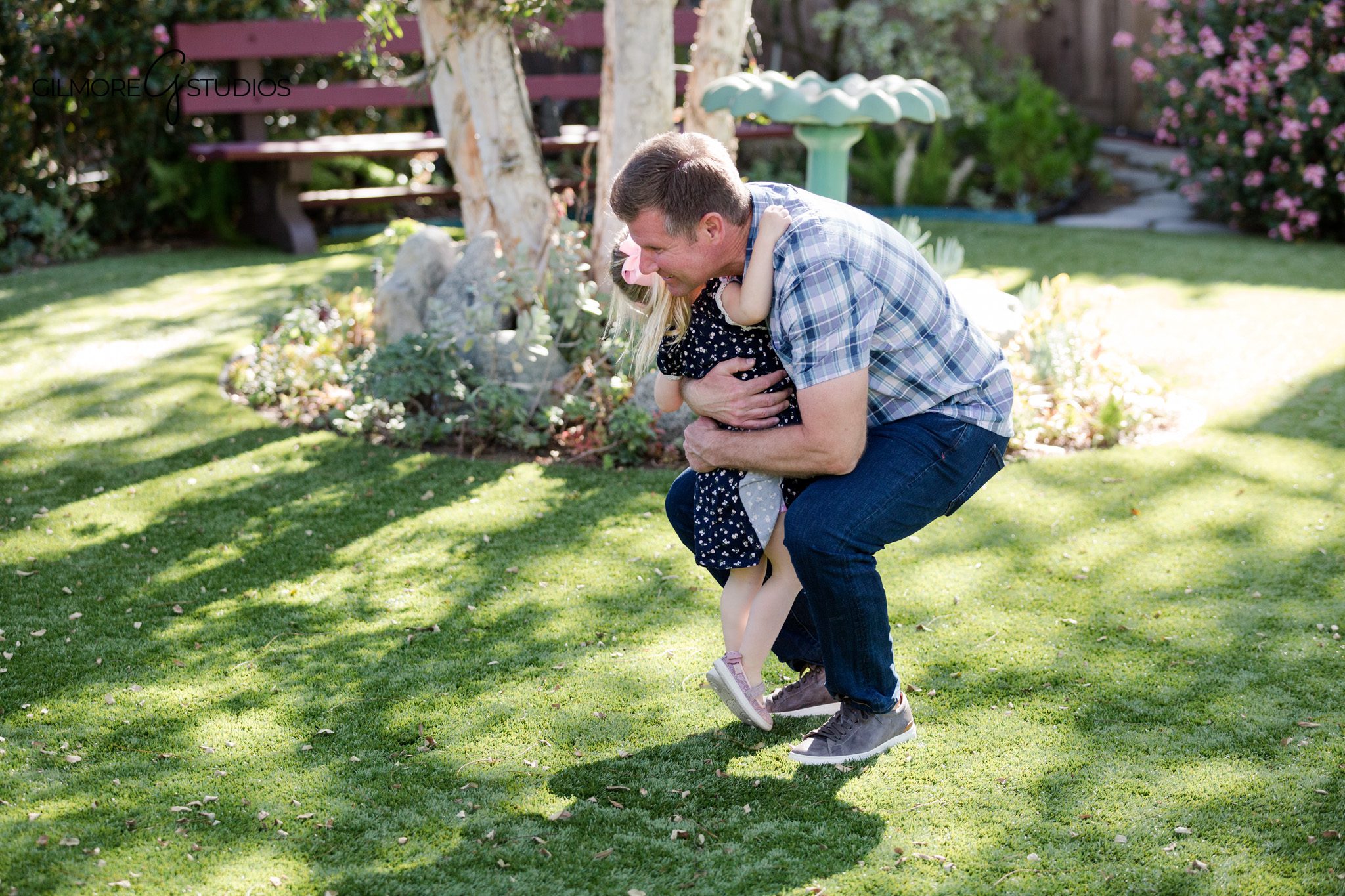 Family photos with porch, lawn, and backyard greenery
Backyard portrait session with candid family moments at home