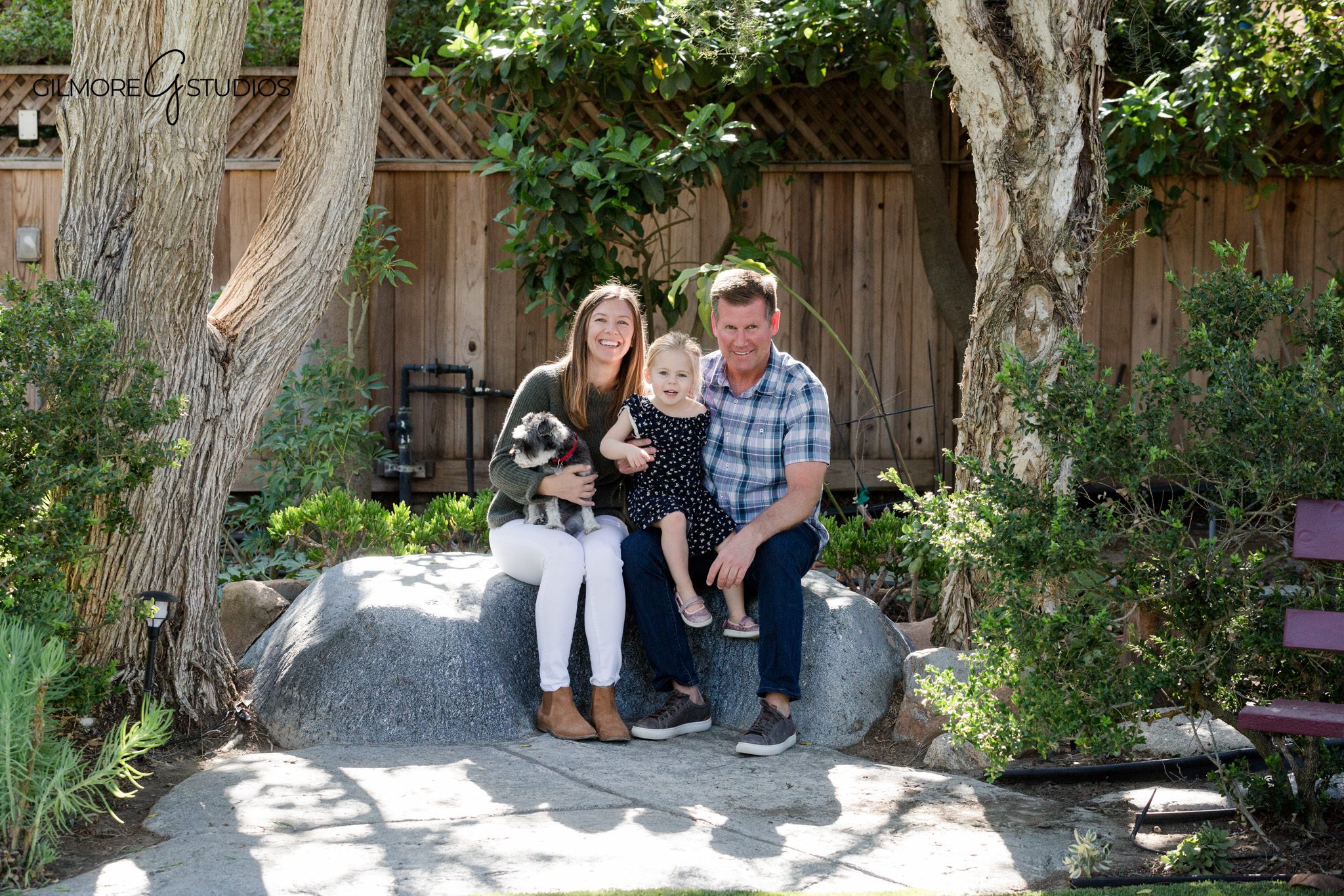 Newport Beach family photographer documenting a relaxed backyard session
Family sitting together on porch steps during backyard garden photos