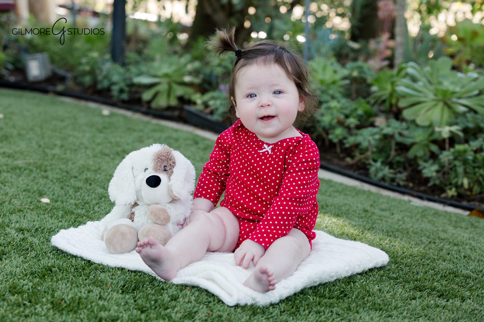 Eight month baby milestone portraits with baby sitting confidently
Nine month baby photos with baby sitting independently in studio