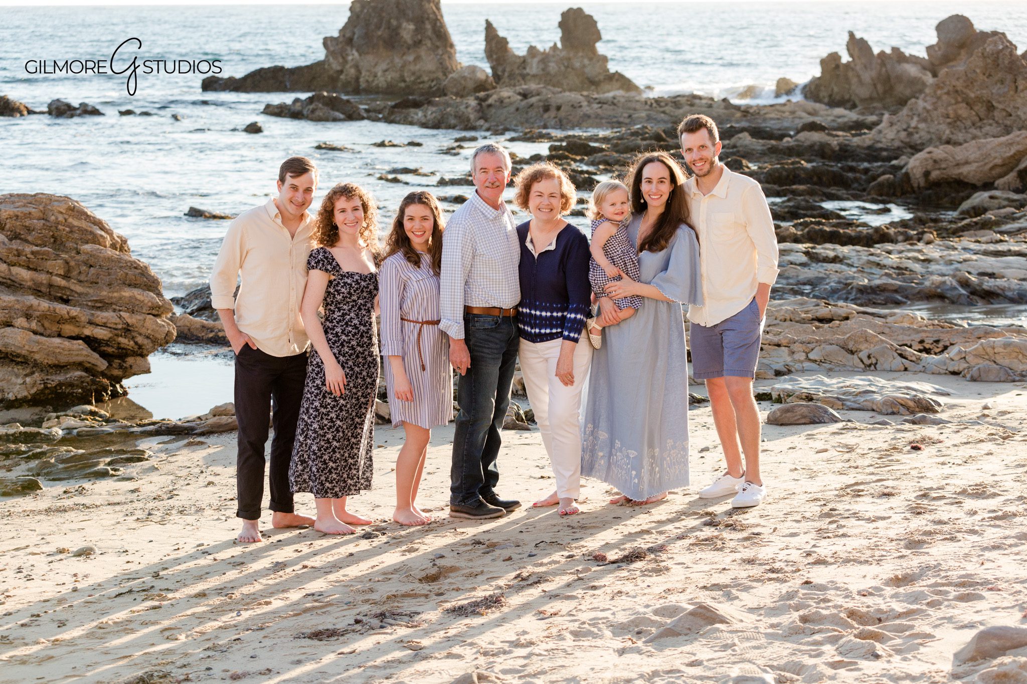 Newport Beach rocky coastline photos with cousins playing near the shoreline
Orange County extended family session with classic coastal portrait styling