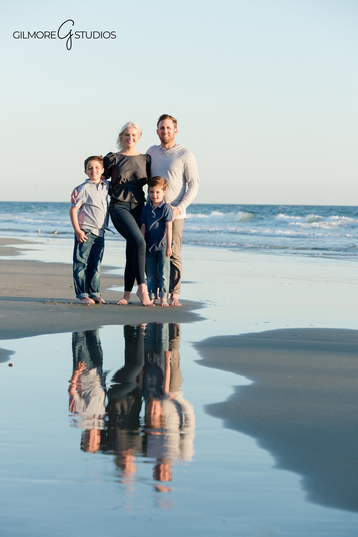 Family walking along the water during Newport Beach sunset photos
Newport Beach photographer capturing family portraits under the pier