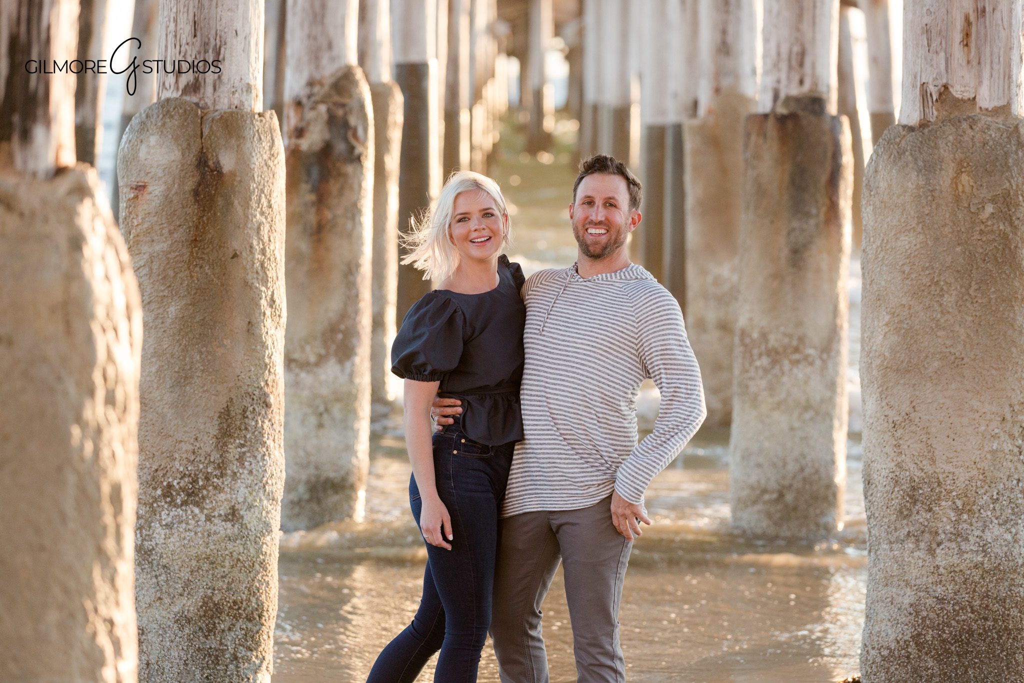 Parents holding hands with children during golden hour beach session
Family photos at Newport Pier with warm sunset glow and ocean reflections