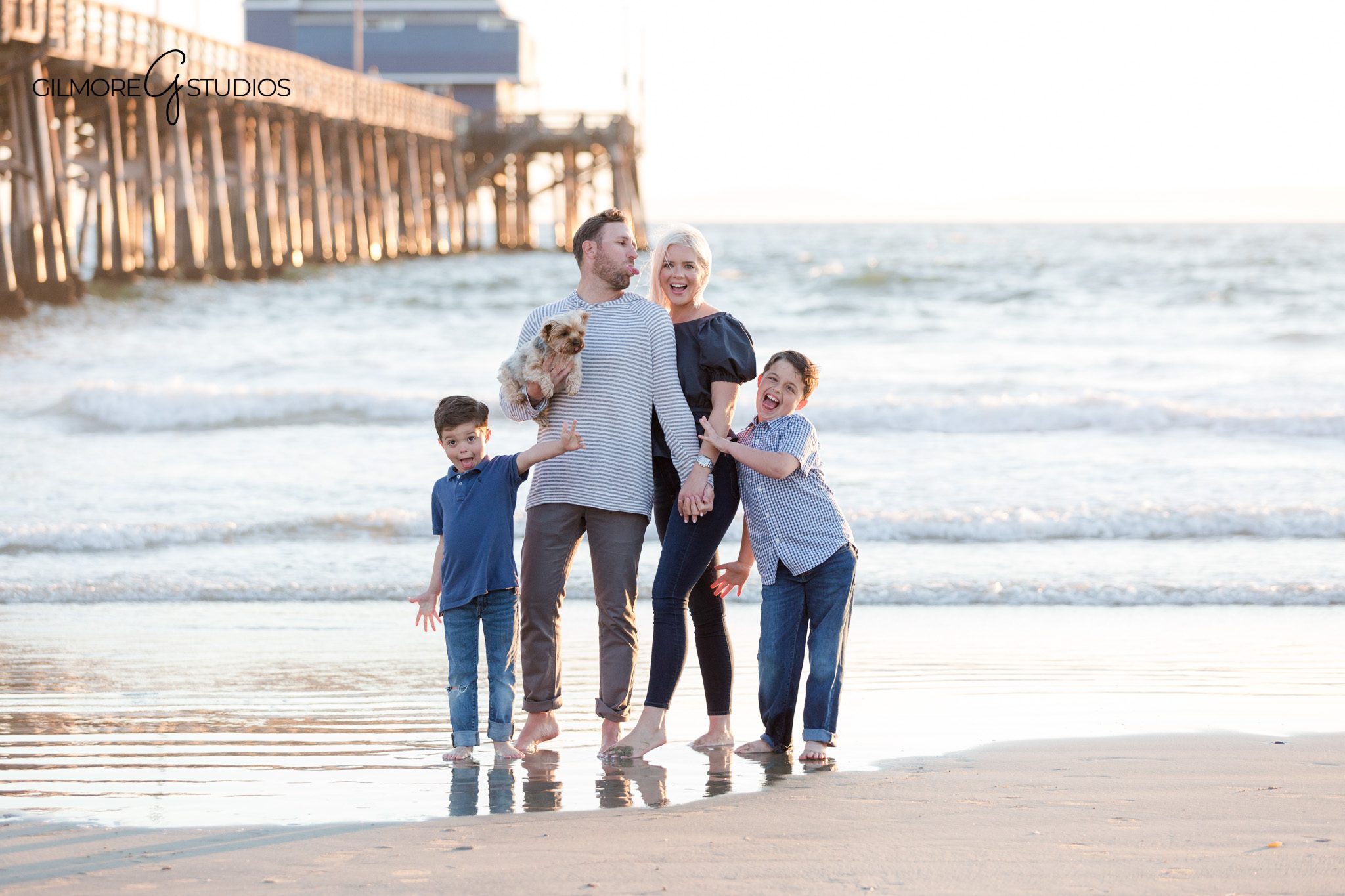 Parent and child portrait near Newport Pier during golden hour
Family walking barefoot on the sand during Newport Beach photo session