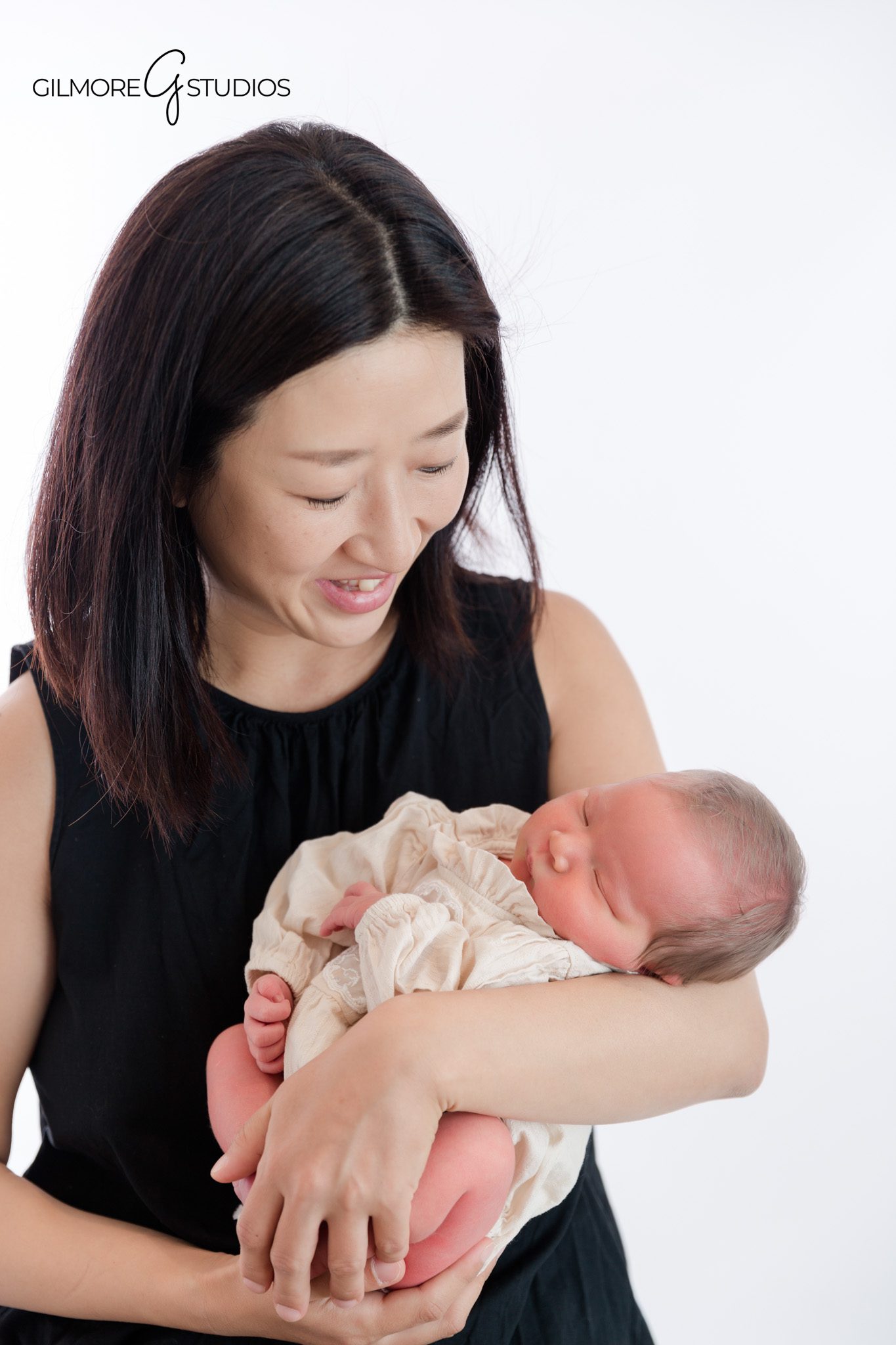 Chandler newborn studio session with soft neutral styling and family portraits
Baby sleeping in parents arms during a newborn photography session in Chandler AZ