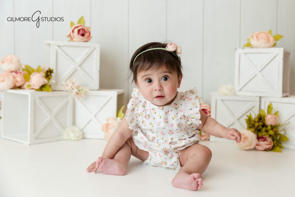 Gilbert AZ sitting up baby girl milestone photographer with floral studio setup
Baby girl sitting up milestone photos in Gilbert Arizona studio