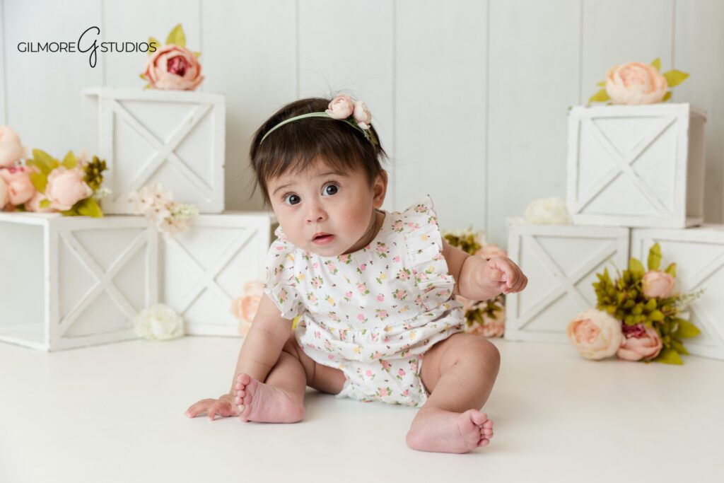 Gilbert AZ baby girl photographer for sitter milestone session
Baby girl in floral romper photographed in studio