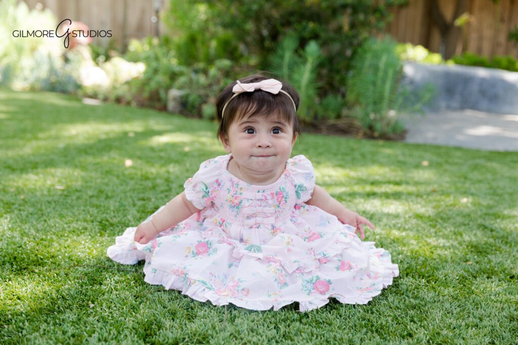 Soft and simple sitting up baby photos in Gilbert AZ
Baby girl milestone portrait with wide eyes and floral headband