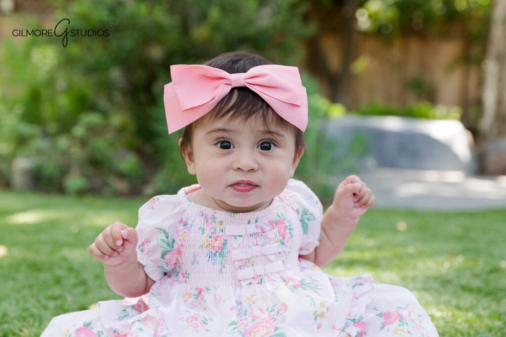 Gilbert AZ sitter session photographer for baby girls
Baby girl sitting up in white and floral studio setup