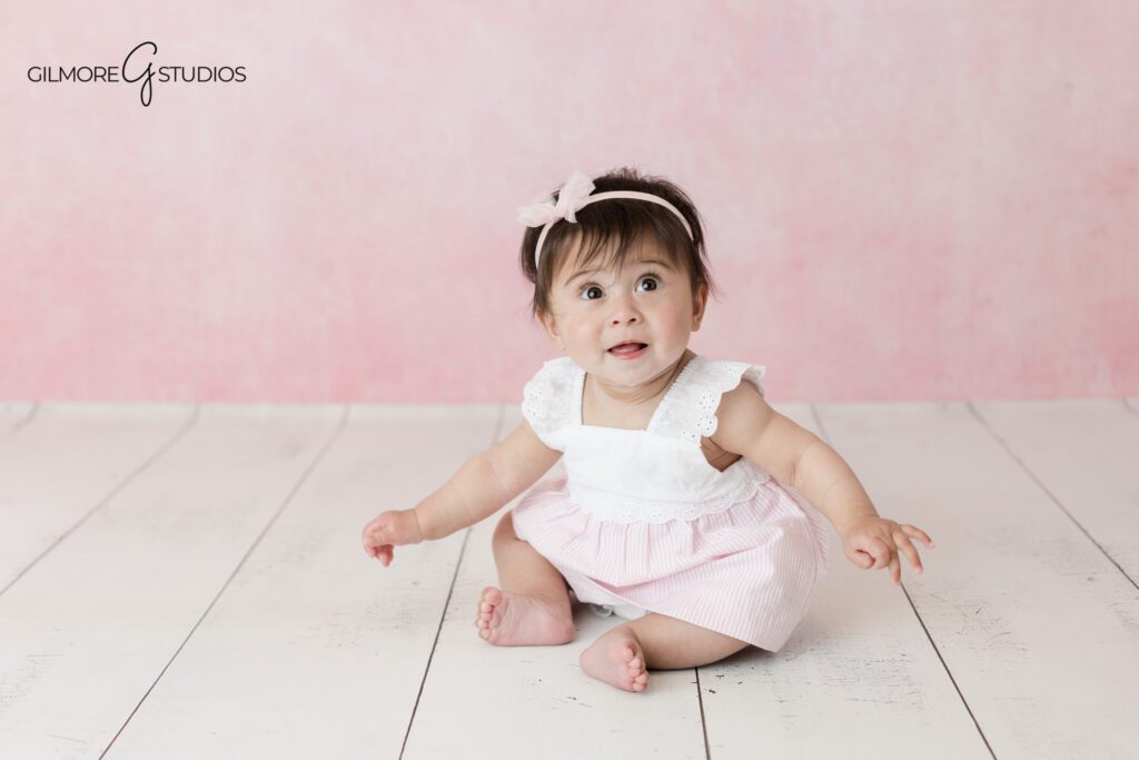 Baby girl tummy time portrait during milestone session
Studio baby milestone photos with white crates and flowers