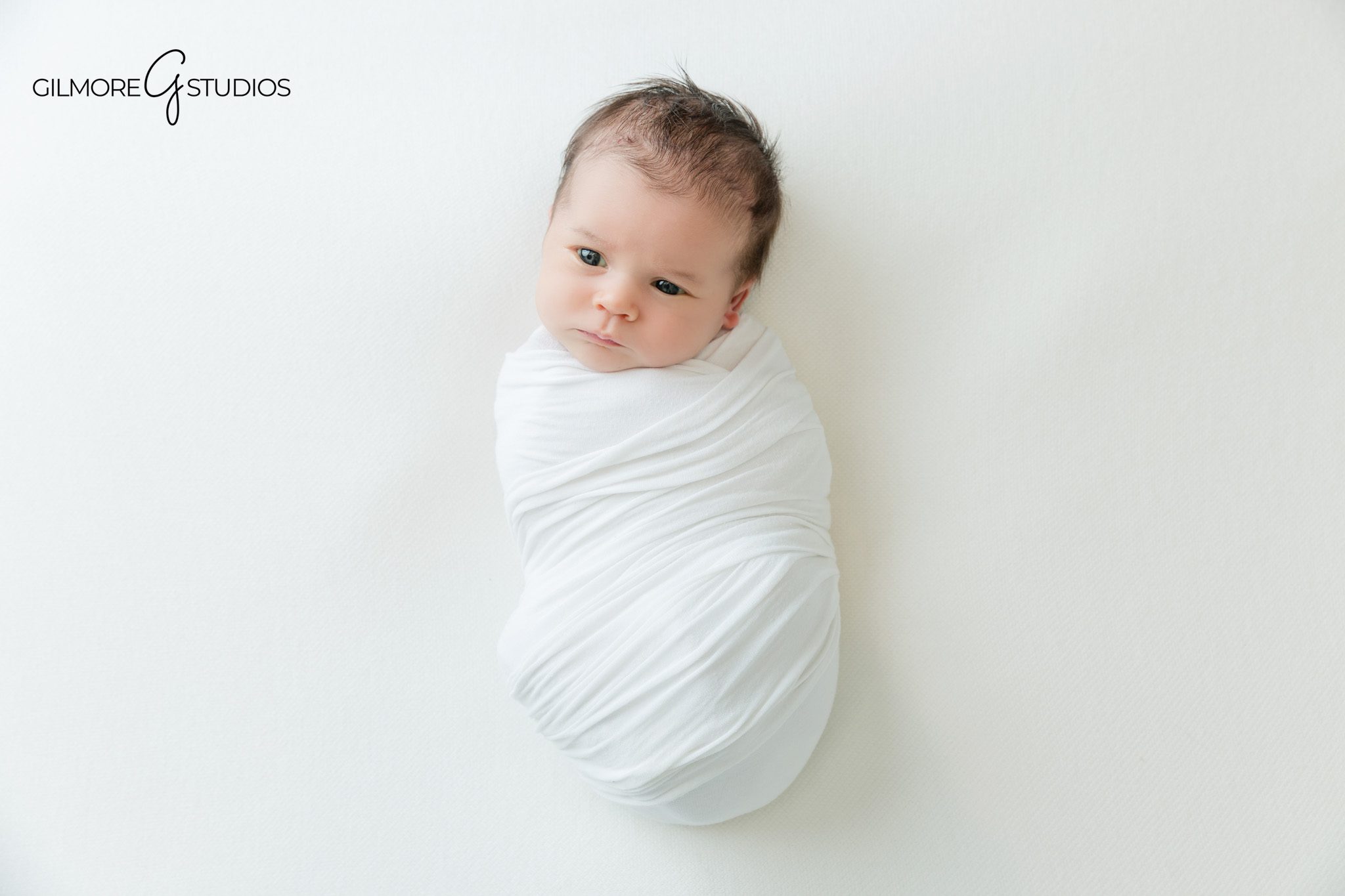 Sweet sibling newborn portrait with sisters kissing baby
Studio newborn session in Gilbert AZ with soft white newborn posing